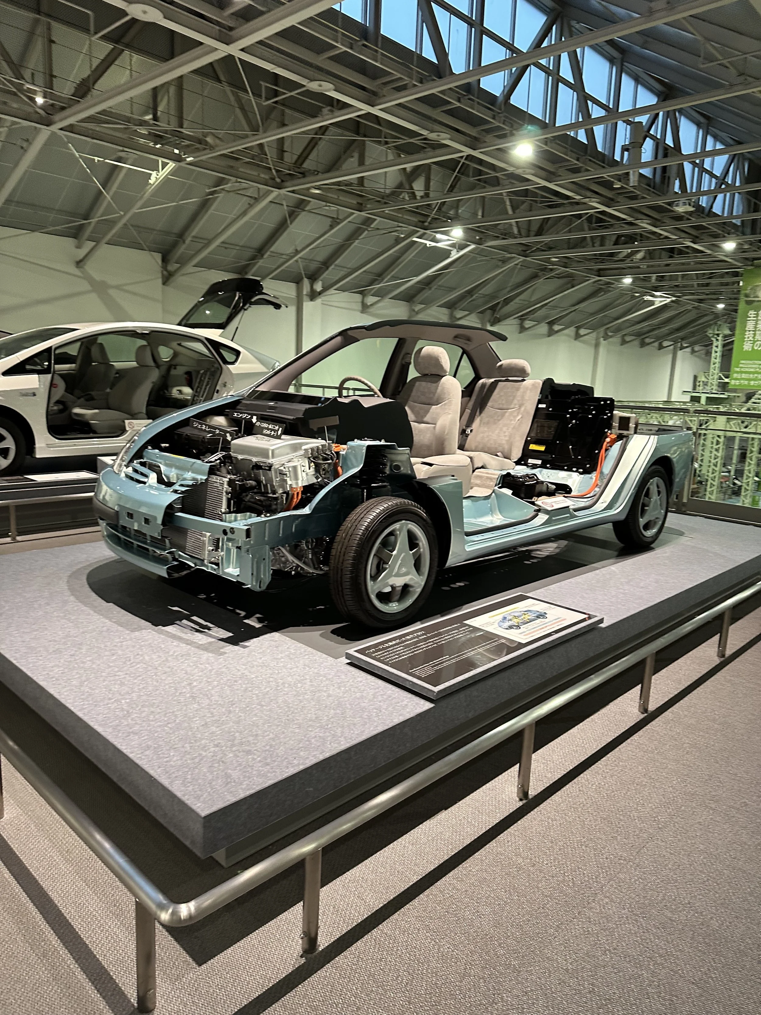 Interior of a car and contents underneath the hood on display at the Toyota Museum.