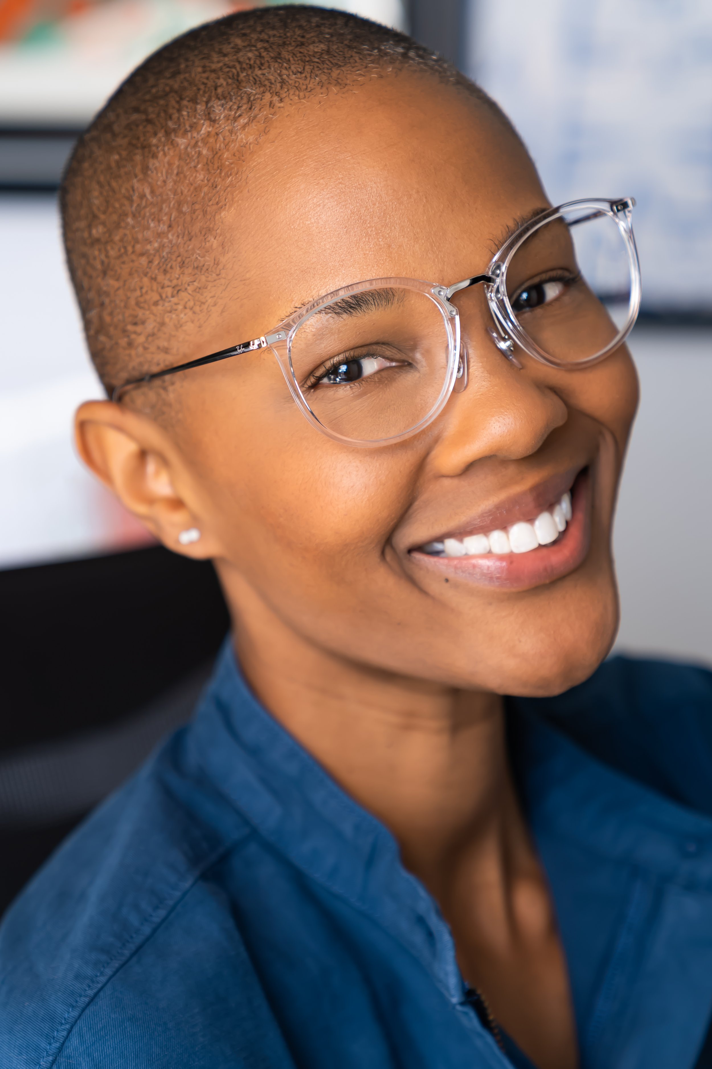 Chernise Taylor smiling in glasses and a blue shirt.