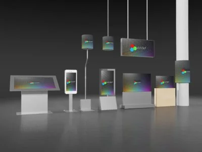 Display of various electronic devices, including a monitor, tablet, and smartphones, all showcasing colorful screens, arranged in a tech store or showroom setting.