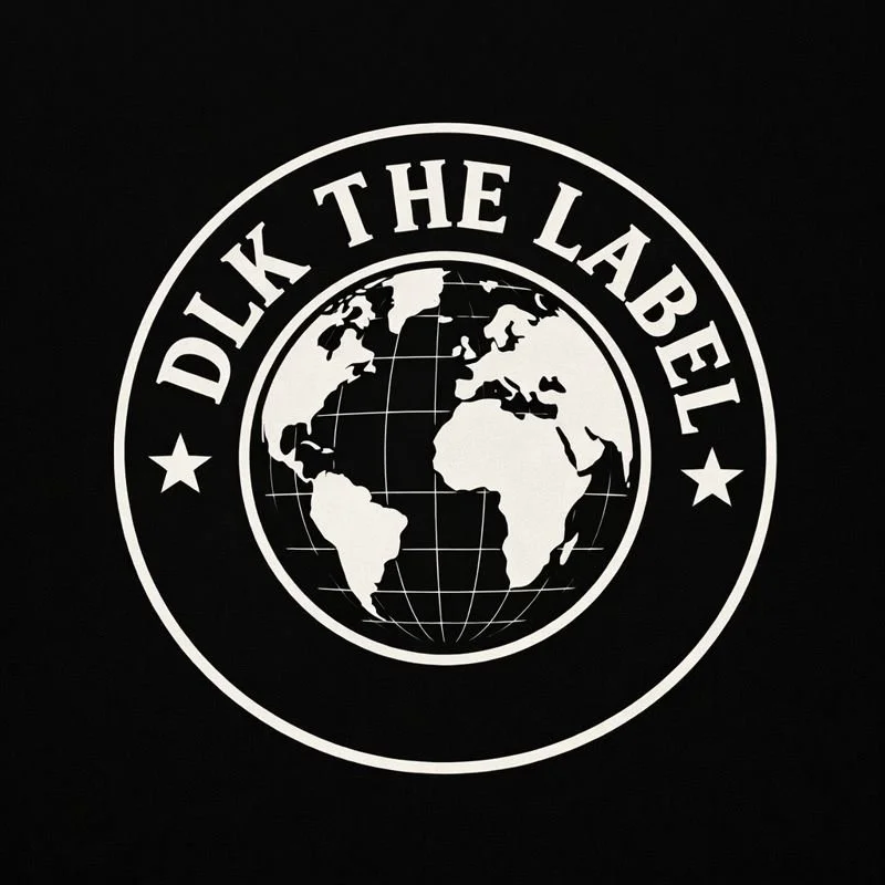 A circular logo with a black background featuring a globe of the world in white, and the words "DICK THE LABEL" curved around the top of the circle, with two stars on either side.