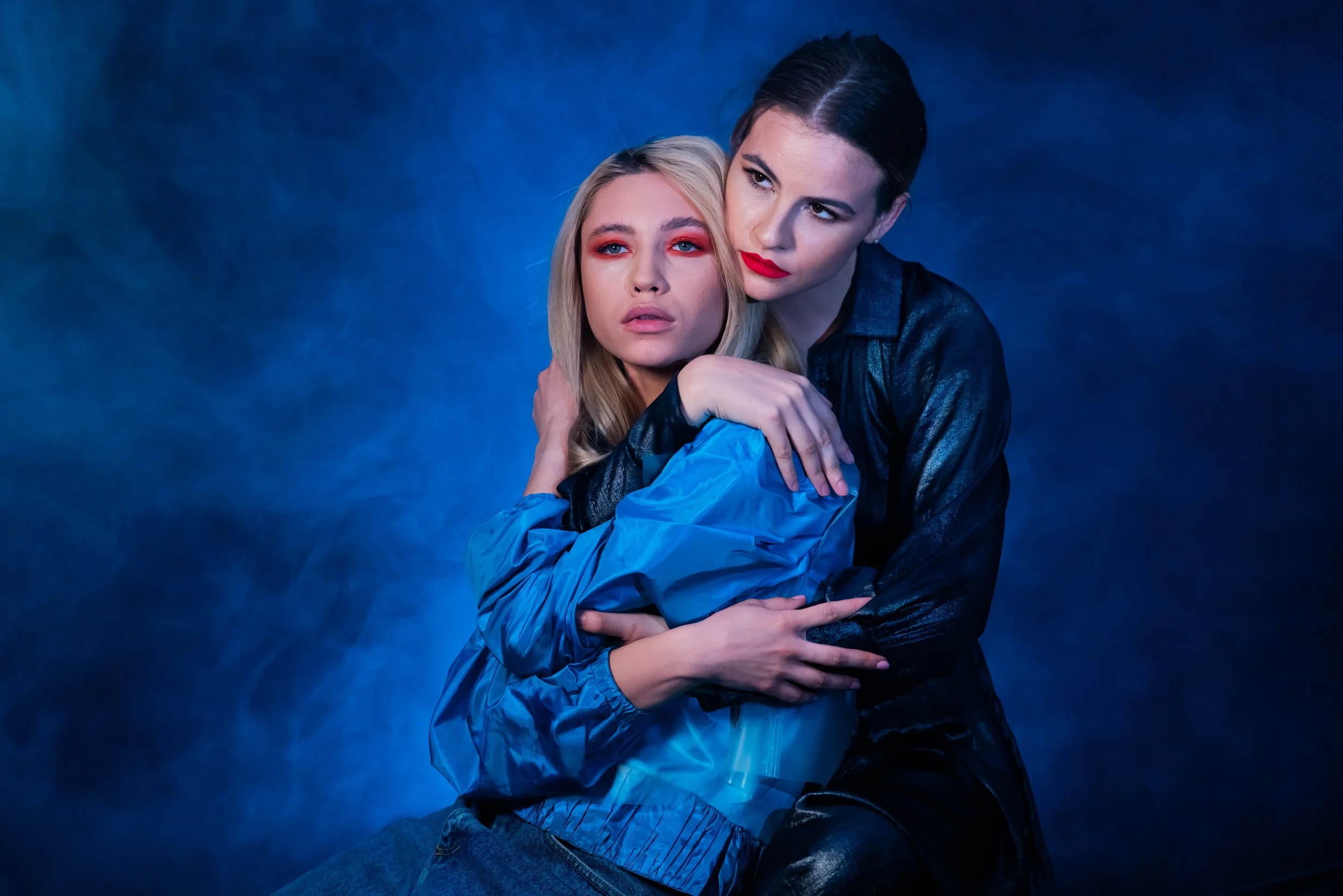 Narrative-driven portrait of a couple featuring theatrical lighting and an intimate, storytelling atmosphere.