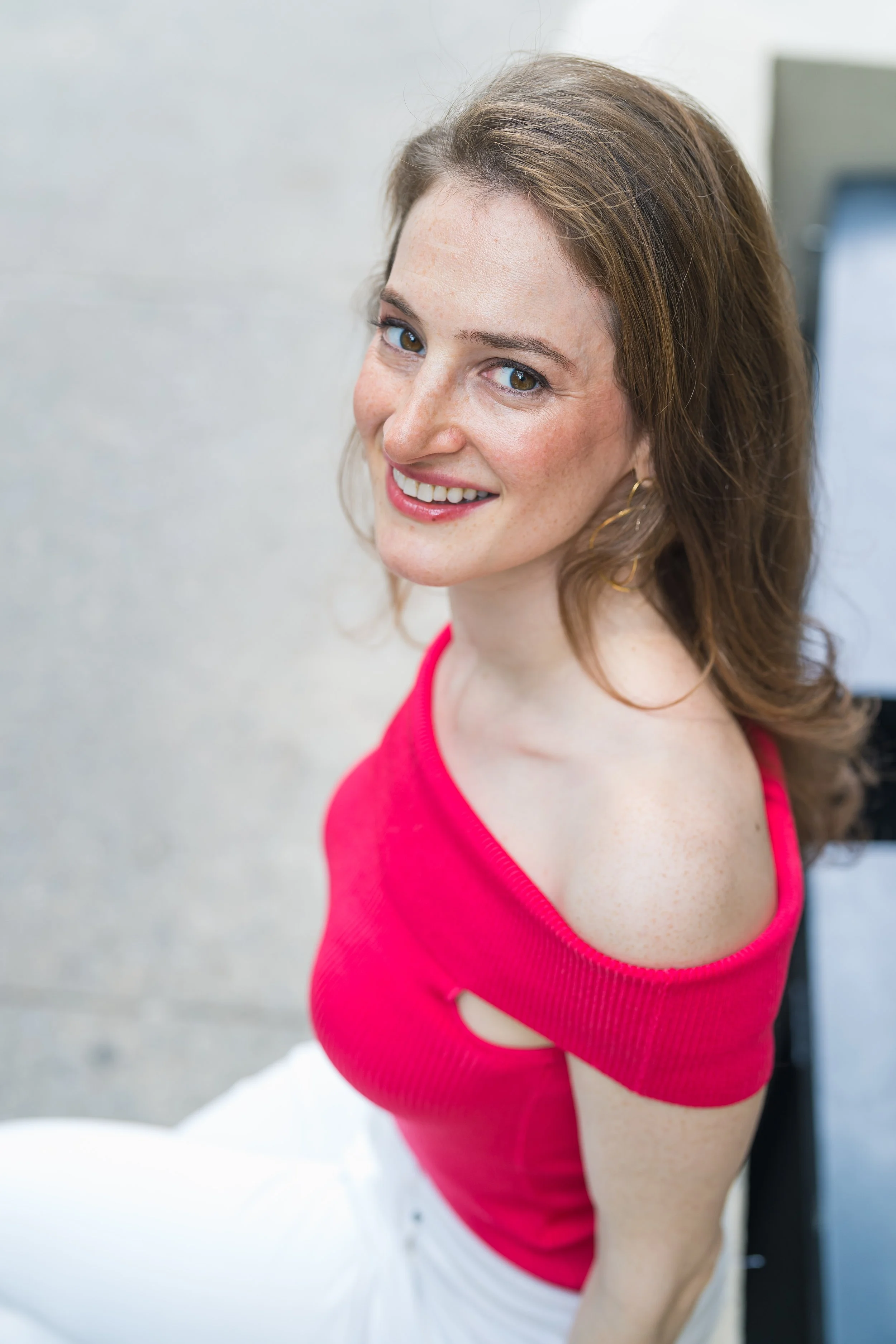 Candid-style outdoor portrait in a Sacramento urban setting, featuring natural sunlight and relaxed posing.