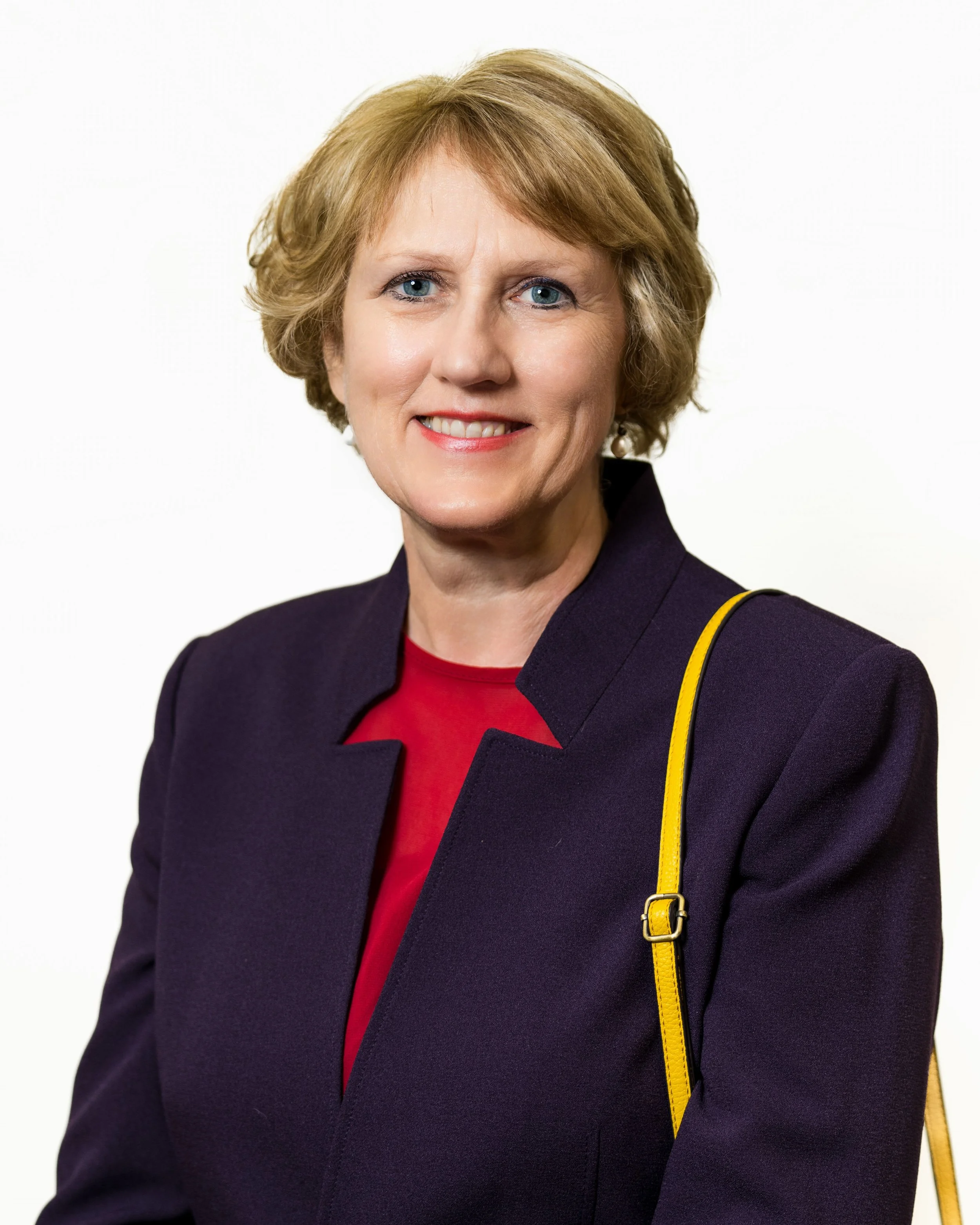 Polished corporate headshot of a professional in Midtown Sacramento, featuring clean studio lighting and a confident expression.