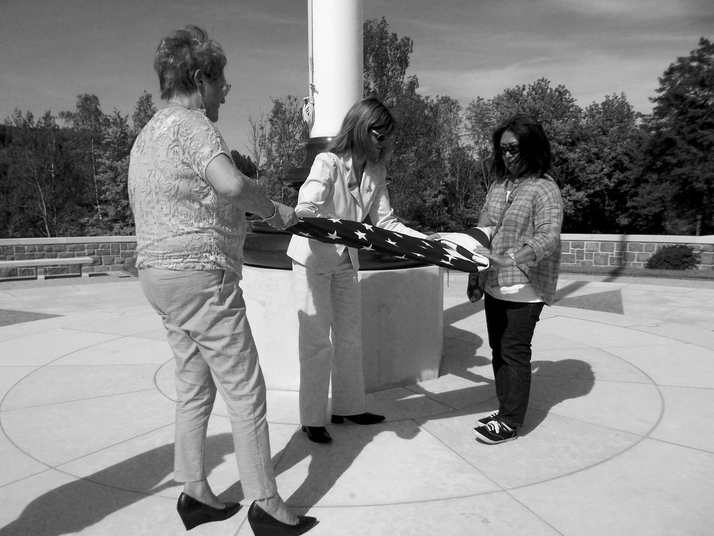 The author participating in the flag folding ceremony held each day at the Èpinal American Cemetery. Photo by Lynn Mallard
