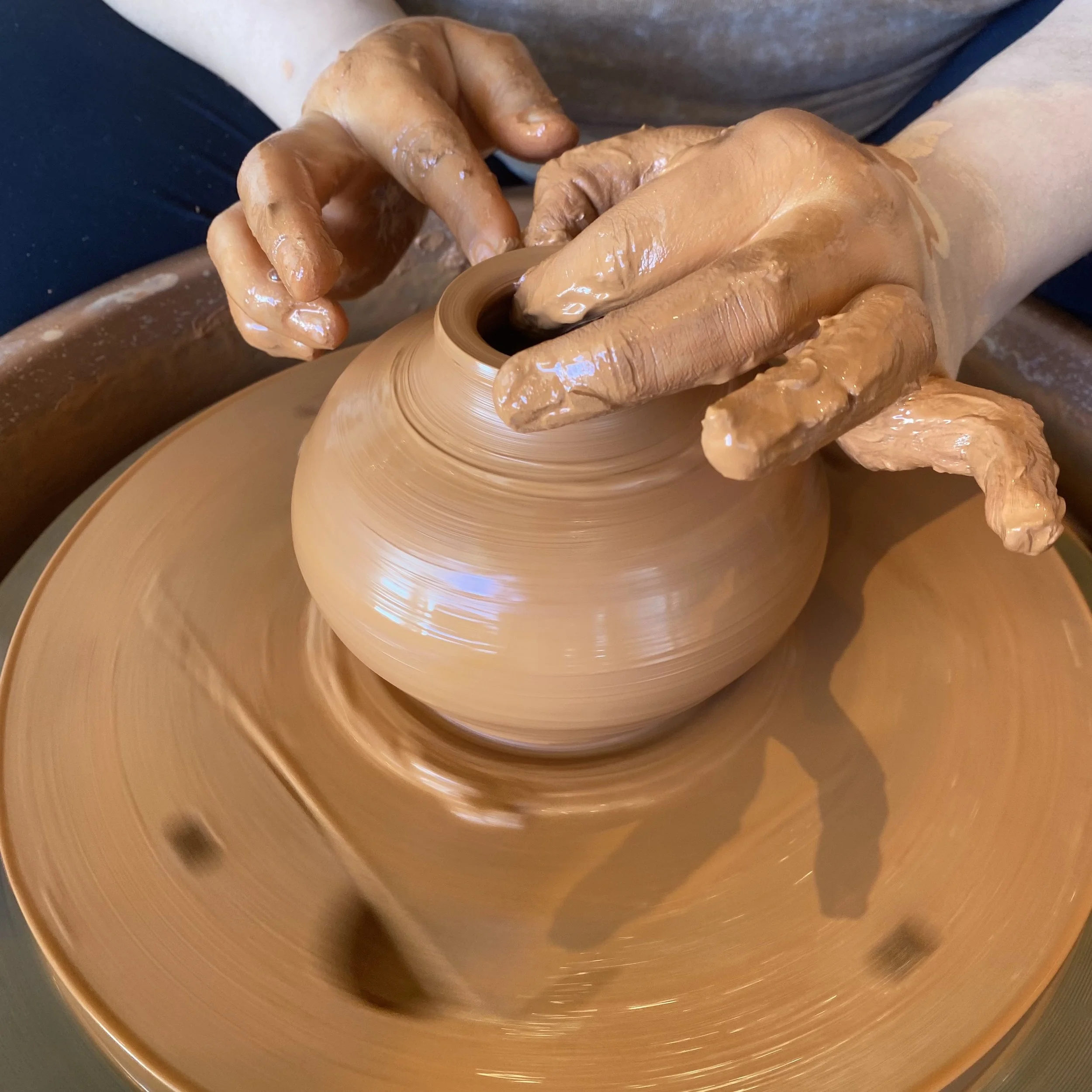 Throwing a clay pot on the wheel