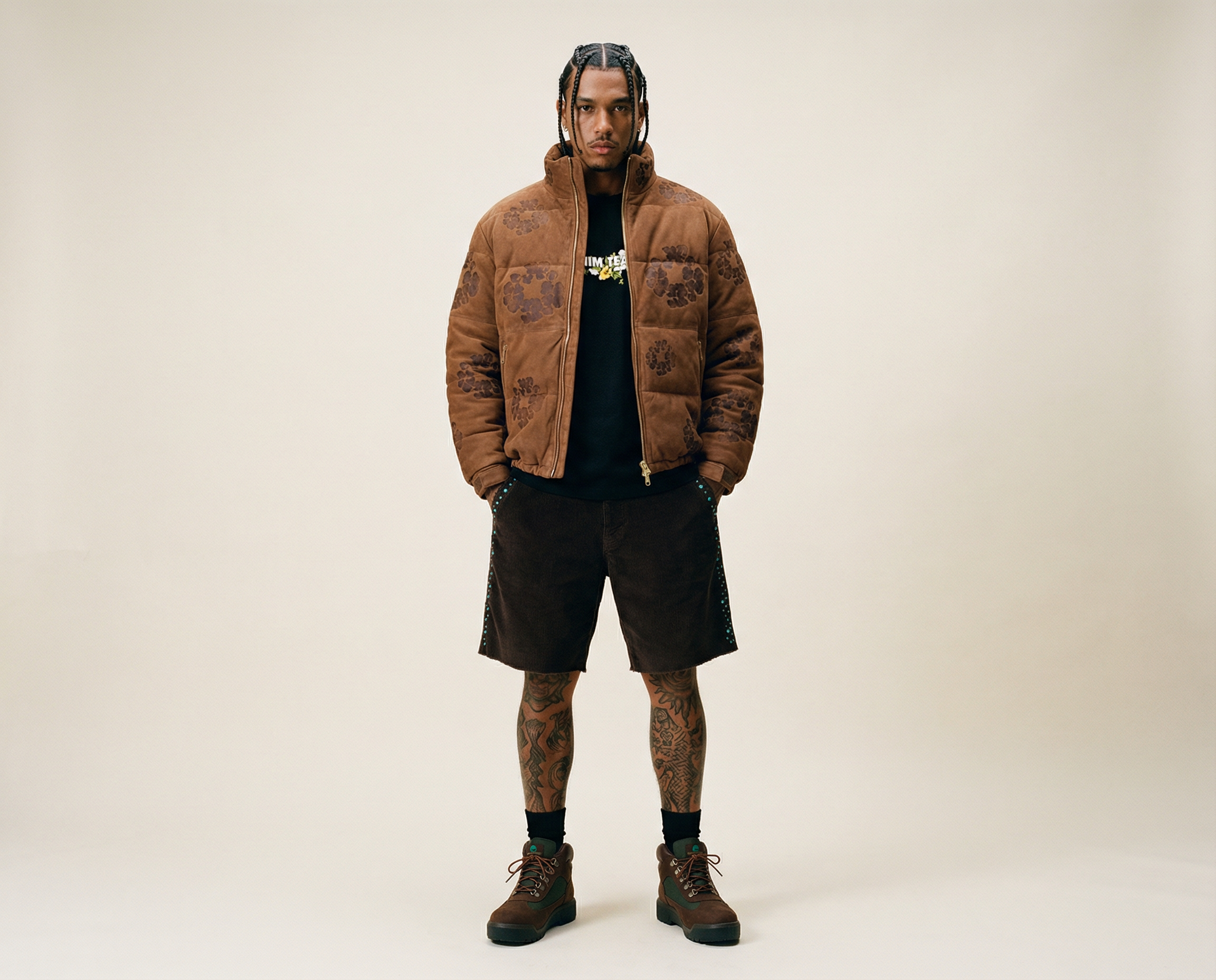 Generated with Kive.ai - hispanic dark skin male model with braid designs on his head_ tattoos on his leg and black socks. hands in his short pockets.png