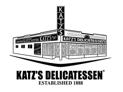 Black and white exterior view of Katz's Delicatessen, established in 1888, showing storefront with signs and signage.