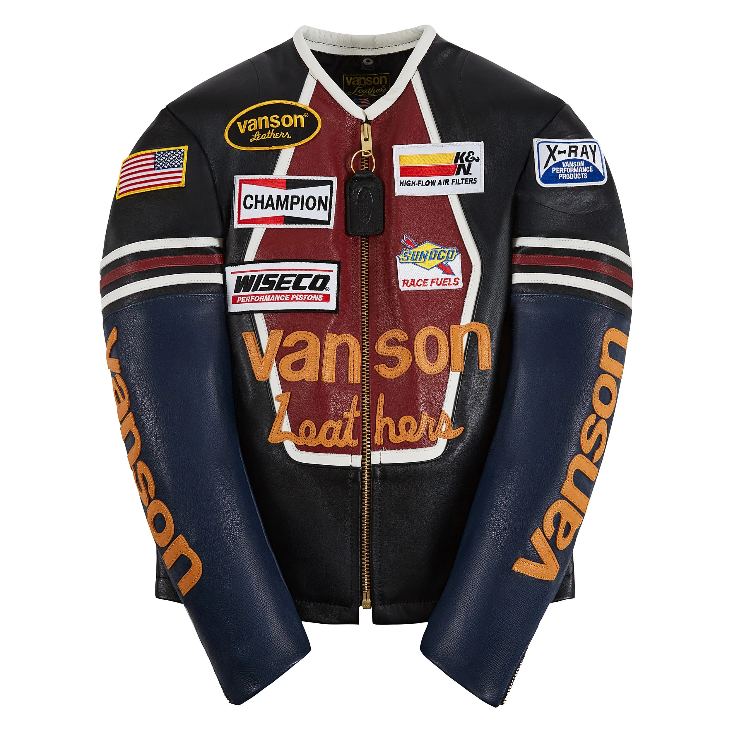 Ghost Mannequin black leather Vanson racing jacket with several embroidered patches, including an American flag, sponsor logos, and text, featuring a gold zipper and orange and white accents.