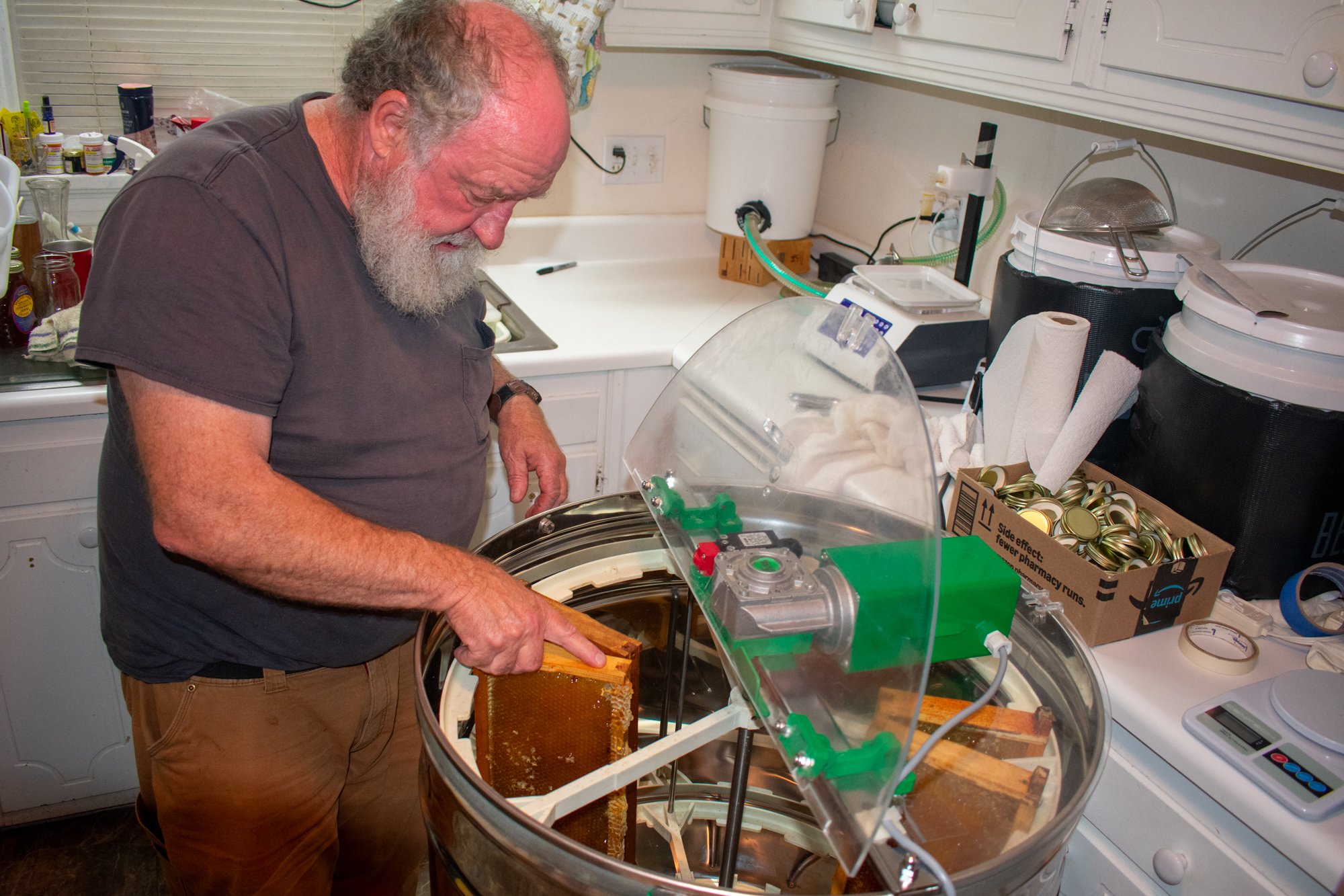 Crump places the frame in the honey extractor. As it spins, honey flows out of the bottom and is collected in a bucket. Once the honey is produced, Crump uses a honey-filling machine to bottle the honey. 

Harvesting and extracting can be physically 