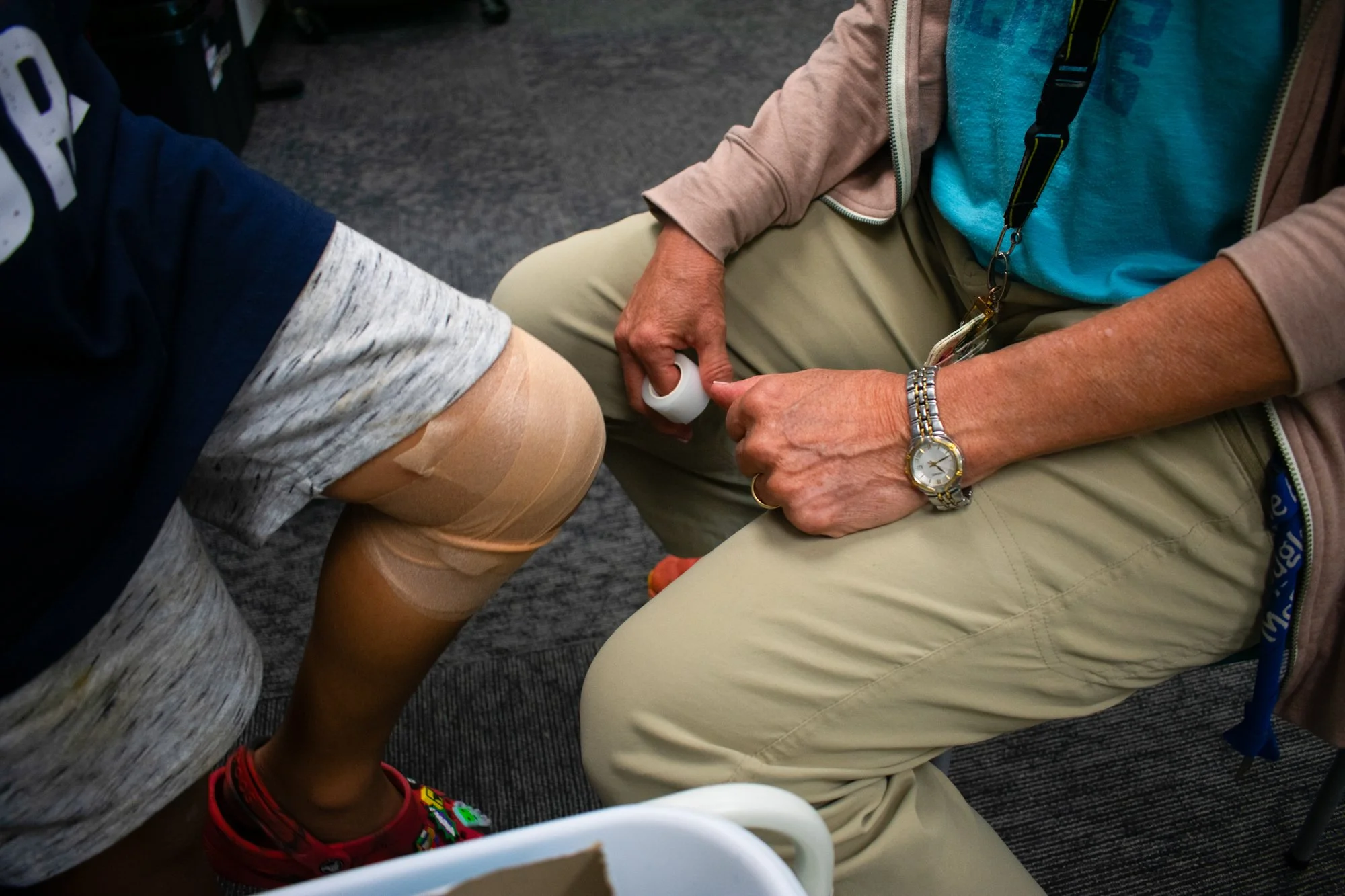 Minogue bandages a student’s knee after he says it hurts to walk, often using placebo techniques to help students feel better. She deals with anxiety and other psychological issues more than first aid and meets weekly with the school social worker an