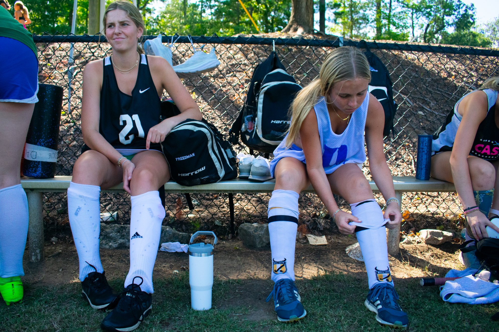 Logan Freedman (left) and Caroline Kantz (right) get ready for practice by putting on their shin guards. When they did not have a game, the team practiced five days a week. The girls get the first five minutes of practice to work on their own skills,