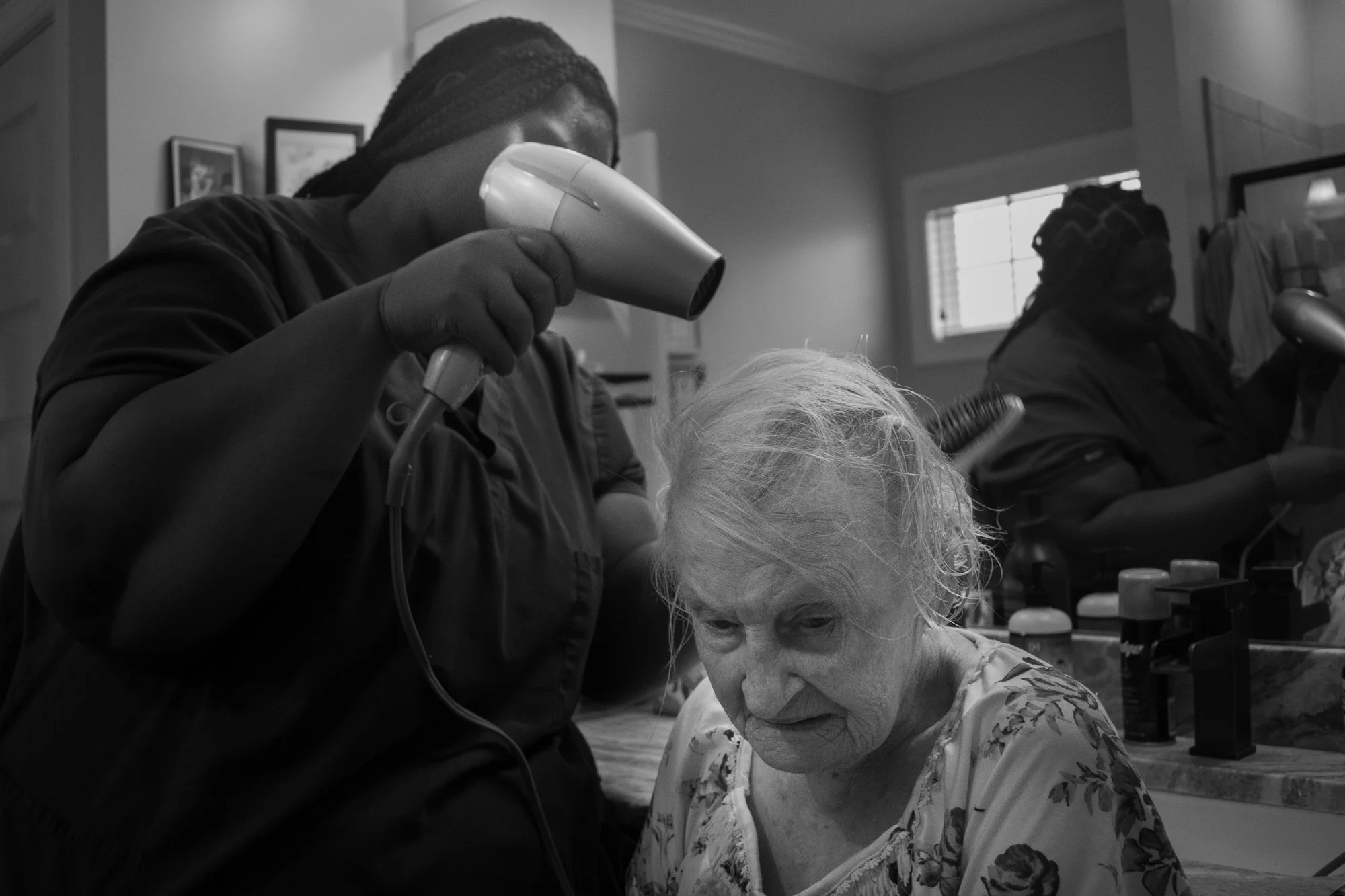Andrellea McNeil blow-dries Mary’s hair after her shower. She said Mary is an extremely easy patient and that she loves her.  

Although the Canters can afford this extra help, many families cannot. According to a 2021 Caregiving Out-of-Pocket Costs 