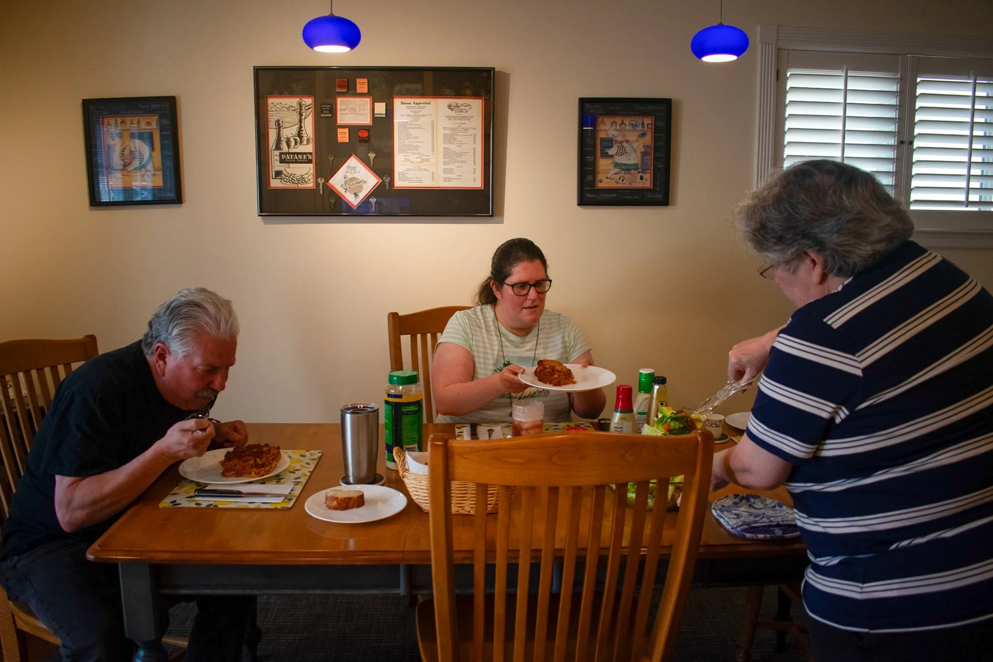 Marge serves Leo and Andrea lasagna on Tuesday, June 3. They have family dinners every night and watch “The Simpsons” or “Frasier.” Marge said family feels like home, and feels like she can do anything when they are by her side. 

“We love her very m