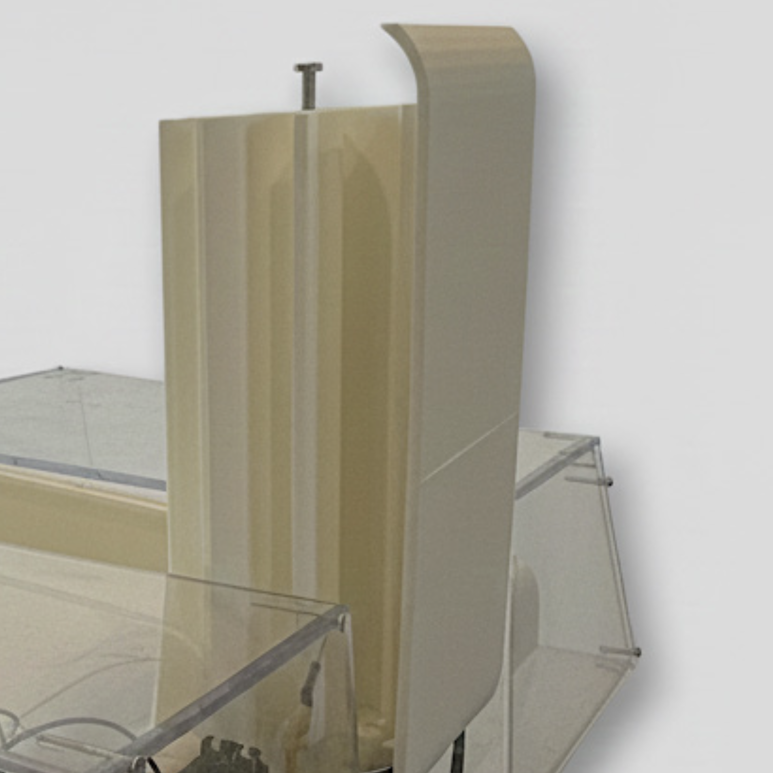 A beige and clear acrylic sneeze guard with metal brackets, used for protective separation at a counter or workstation.