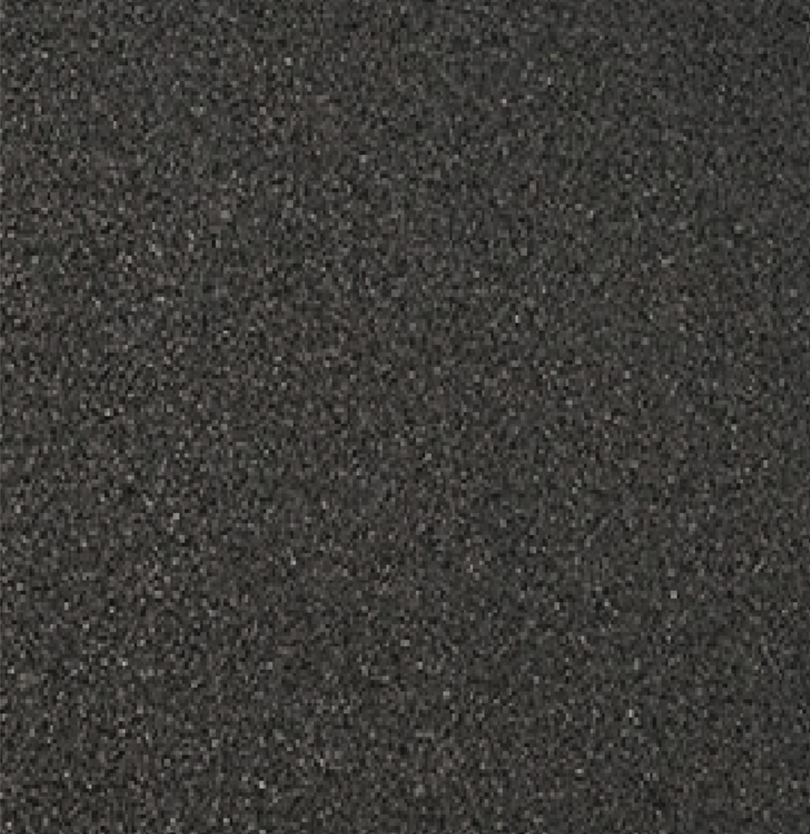 Close-up of a textured black asphalt surface.