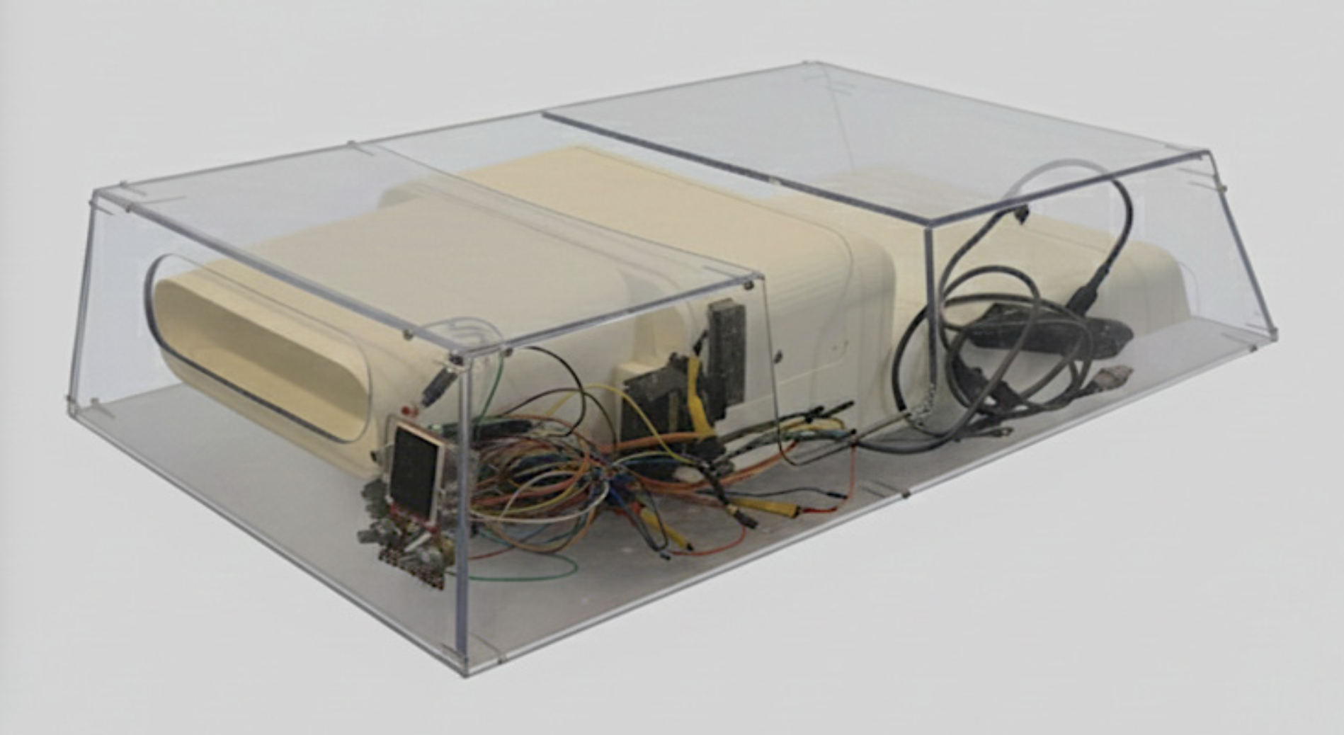 A transparent rectangular box housing electronic components, wires, and circuit boards inside.