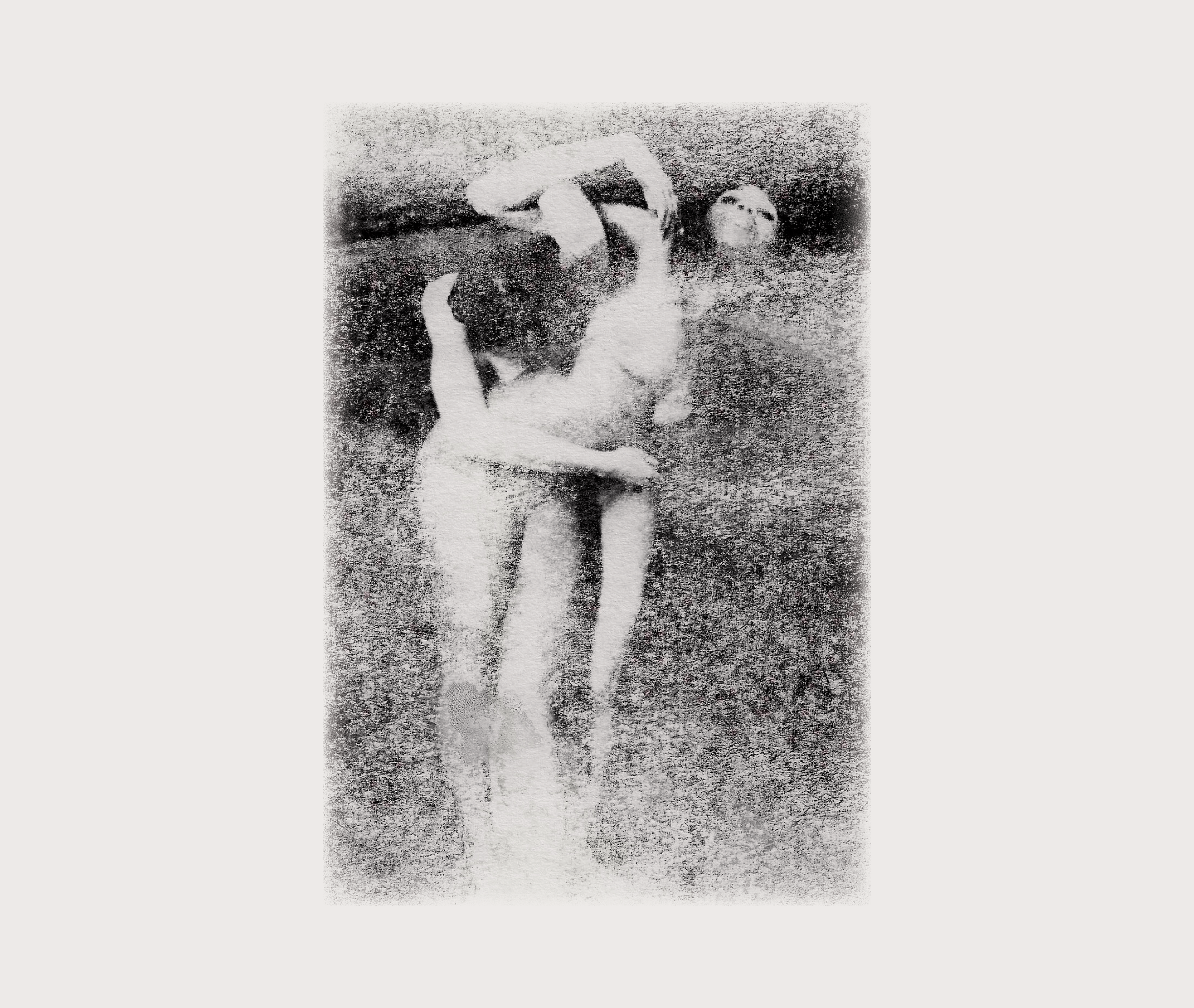 A black and white artistic photo of two nude women embracing each other, with one woman kissing the other on the cheek, and a third woman seen in the background.