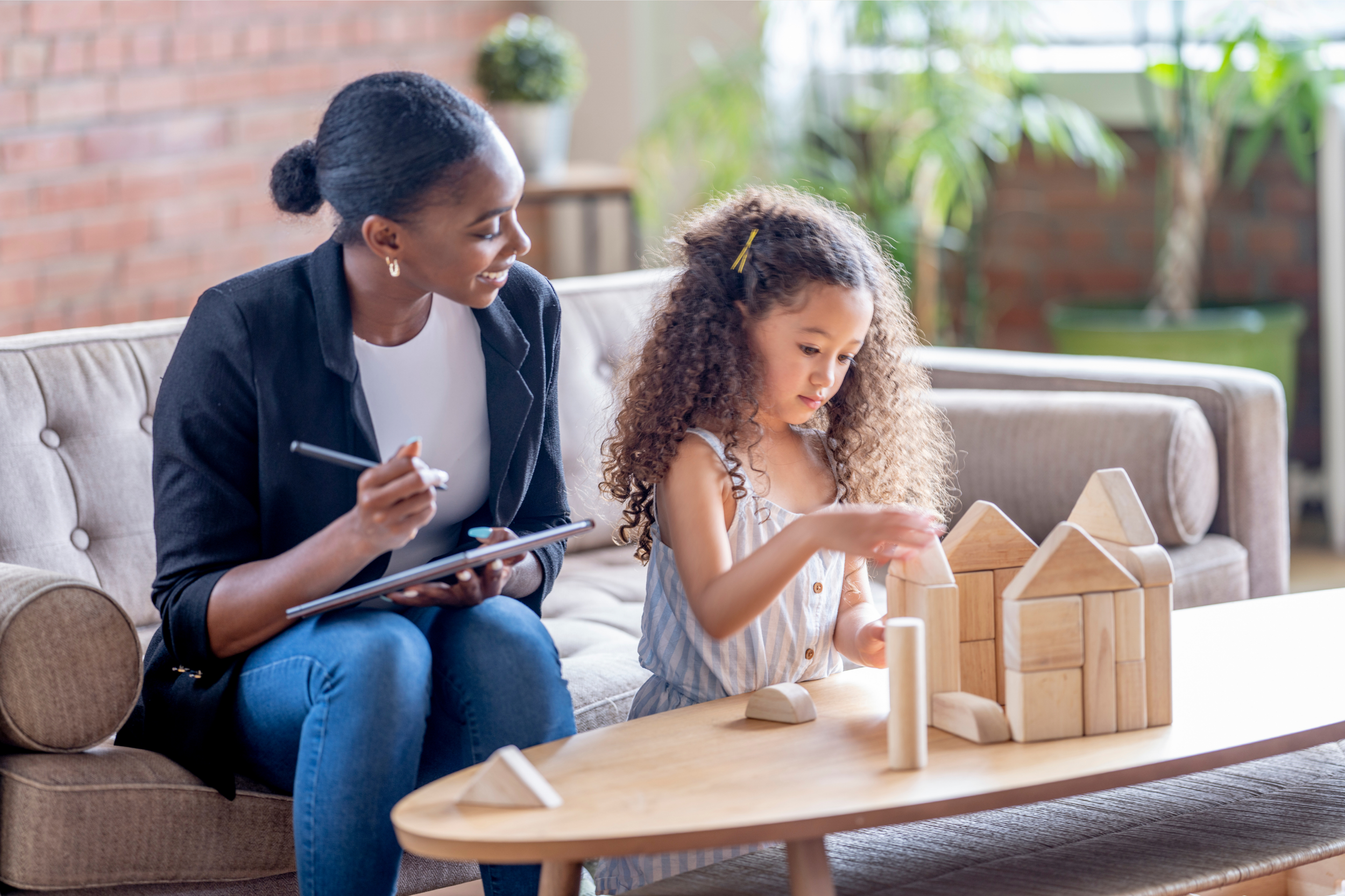 Play therapy session with a counselor and child using wooden blocks at Meadowbrook Counseling in Athens, Alabama.