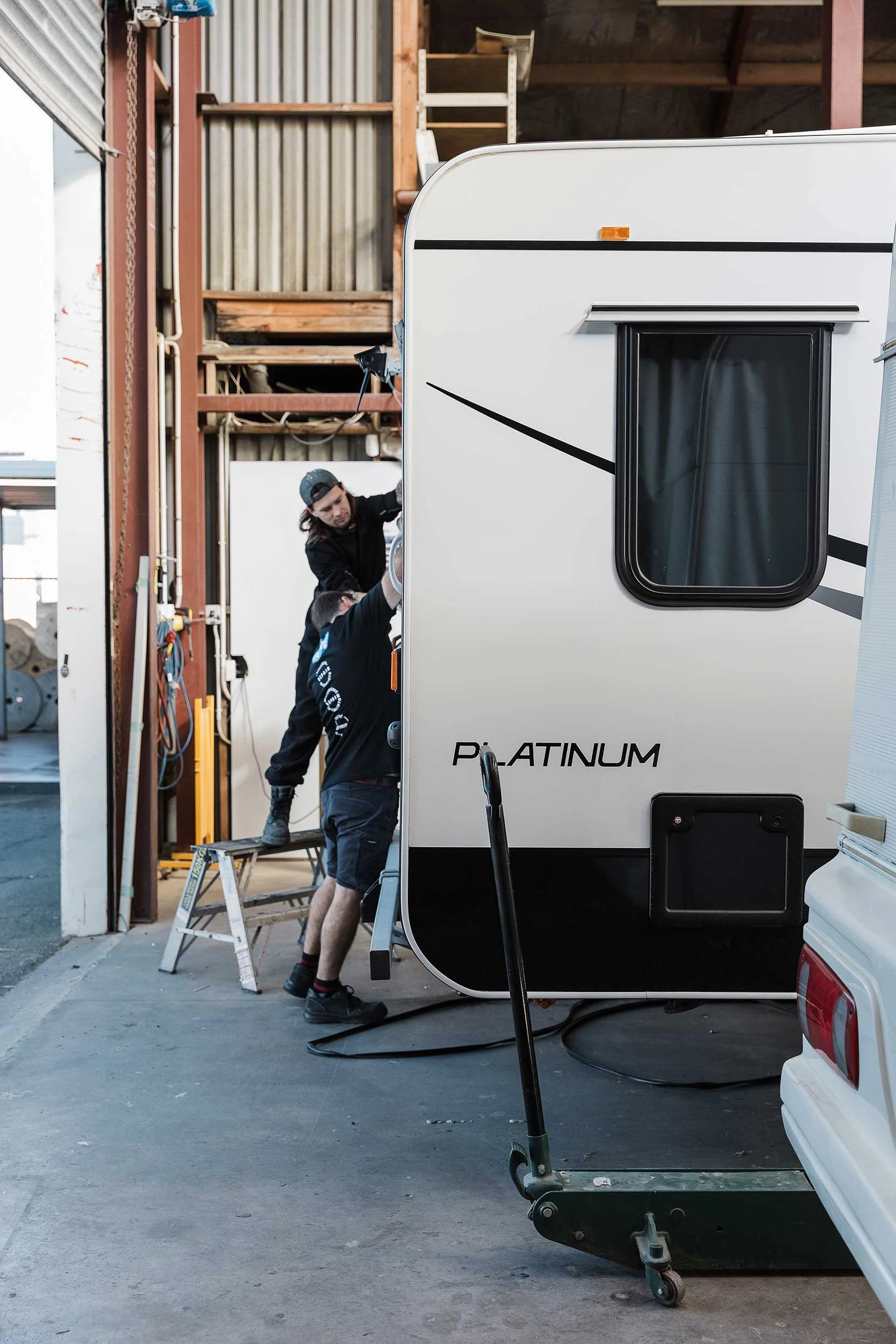 Two A&M Panel Repairers providing insurance repair work on a motorhome