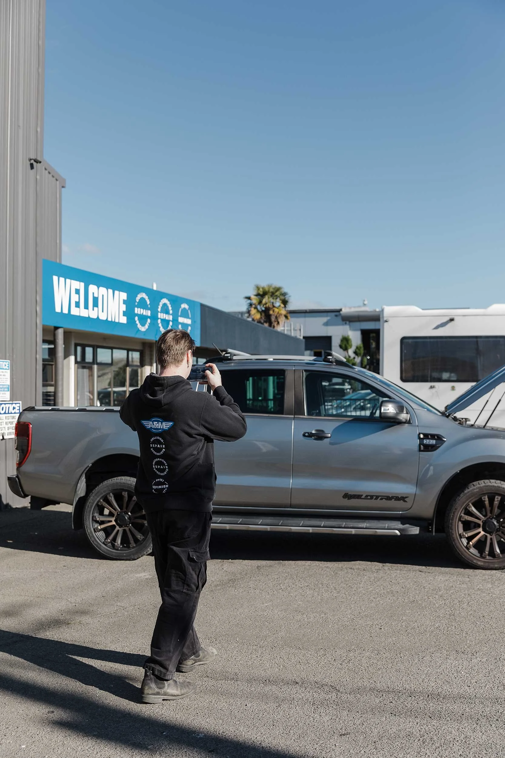 A&M Panel fleet collision repair and insurance liaison photographing vehicle to record damage for repair