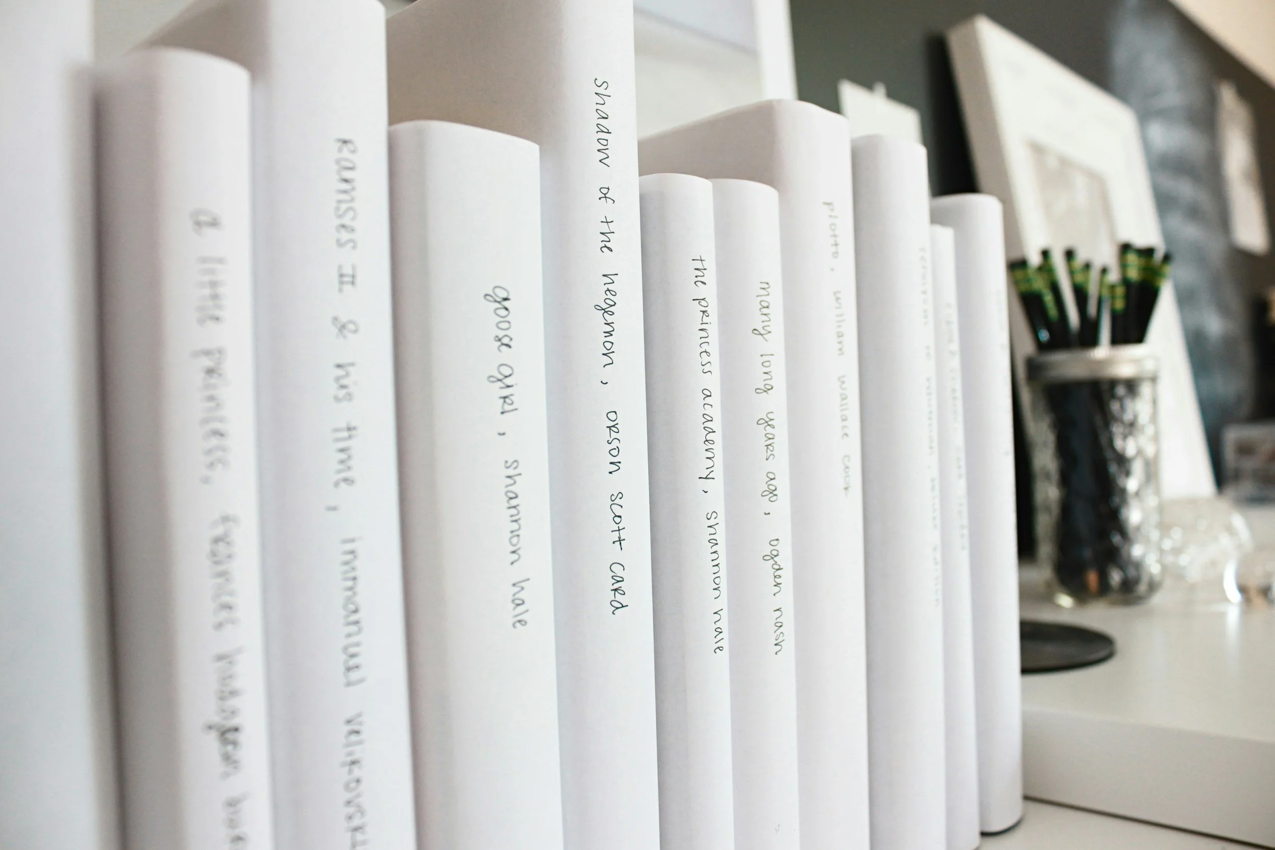 White books standing against each other with hand written labels