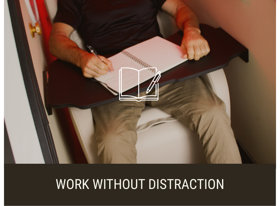 Client sitting and working in mild hyperbaric oxygen therapy chamber (mHBOT) at Airox Wellness, Lennox Head, NSW. 