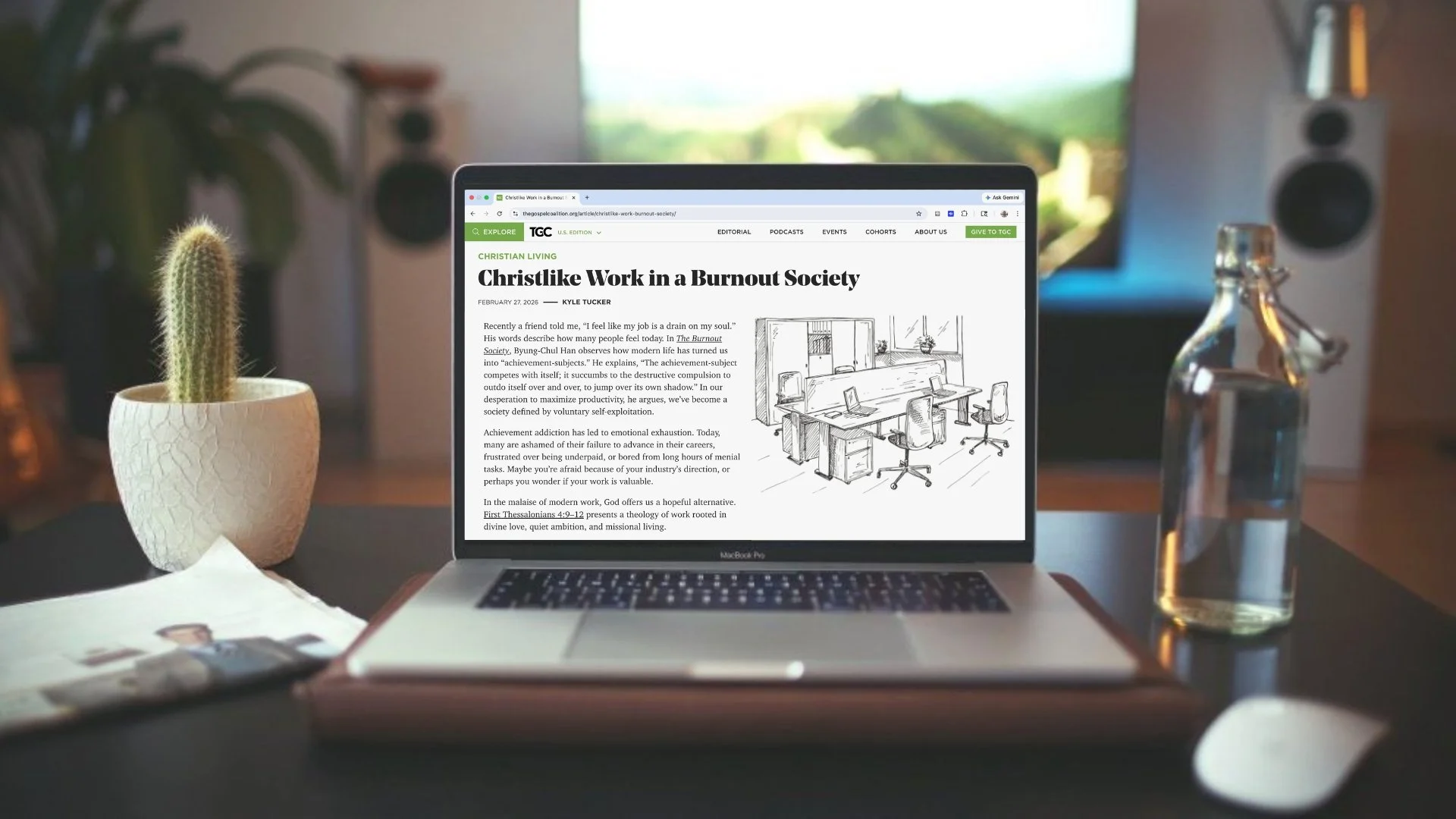 Laptop displaying an article titled 'Ancient Missional Practices for Modern Renewal' on a desk with a cactus in a white pot, a glass bottle of water, a newspaper, and a computer mouse.