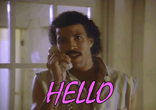 A man with dark curly hair and a mustache speaking on a landline phone, with 'HELLO' written in pink text at the bottom.