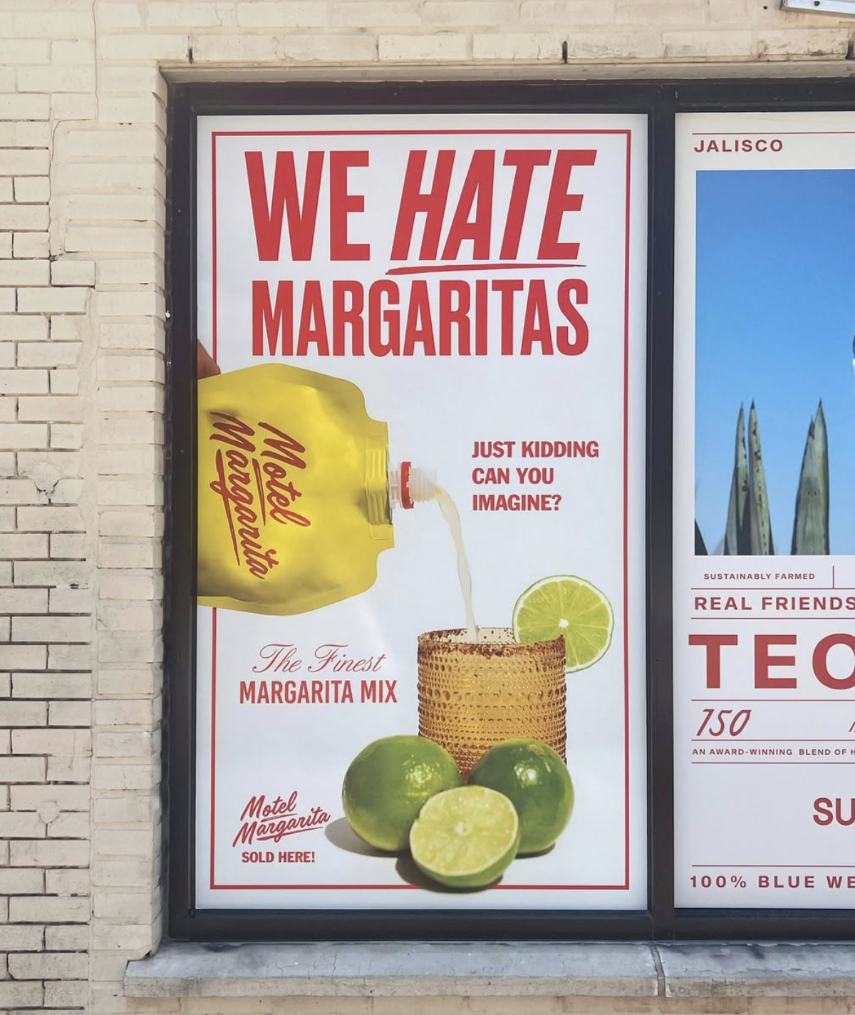 Sign advertising margarita mix with a humorous message, showing a bottle of margarita mix pouring into a glass with lime slices, and the text 'We Hate Margaritas' and 'Just Kidding Can You Imagine?'.