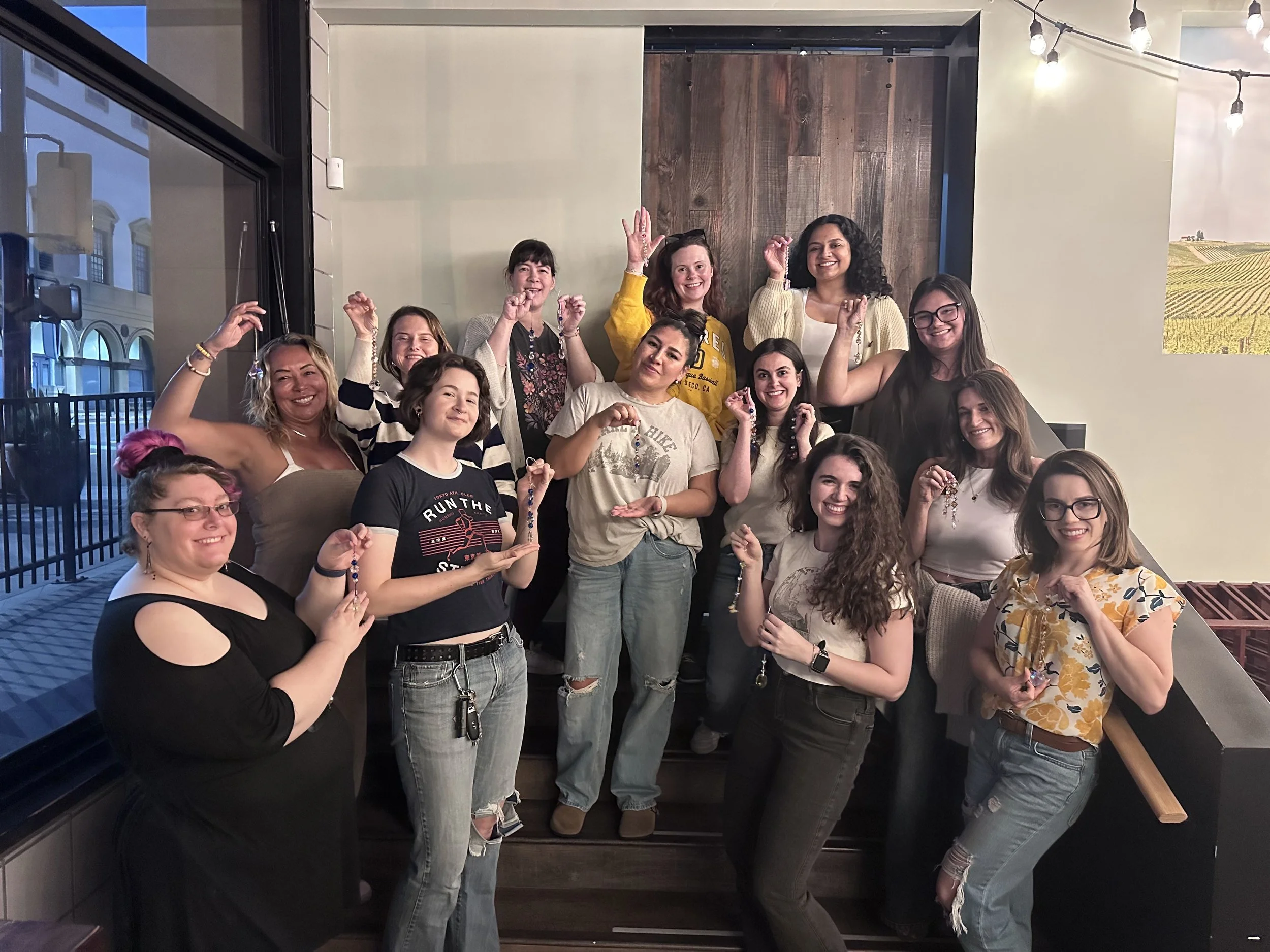LetsGoGirls San Diego members posing together indoors at a community gathering, smiling and celebrating friendship, connection, and women’s empowerment.