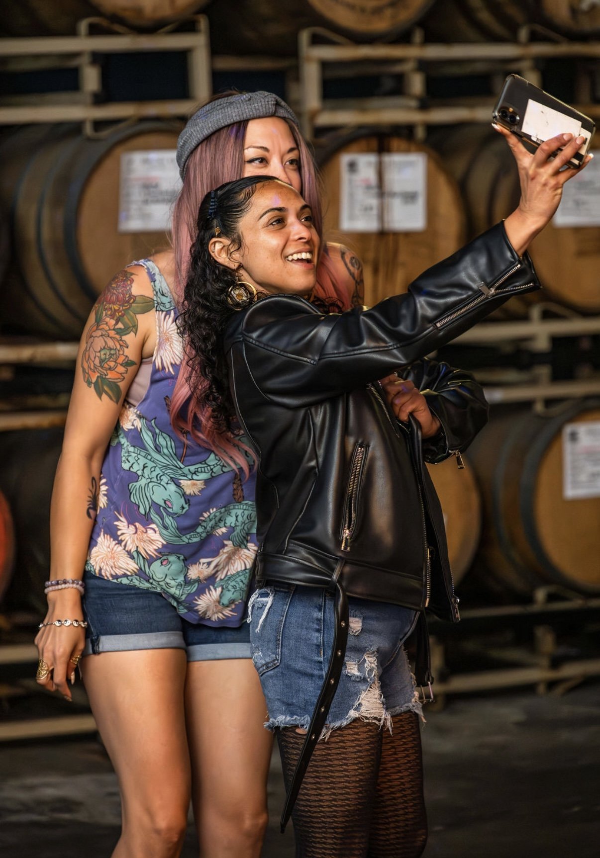 LetsGoGirls San Diego members taking a selfie together during a social gathering, smiling and enjoying a fun community event in a casual winery setting.