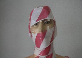 Person wearing a balaclava with red and white stripes, sunglasses, and light brown skin.