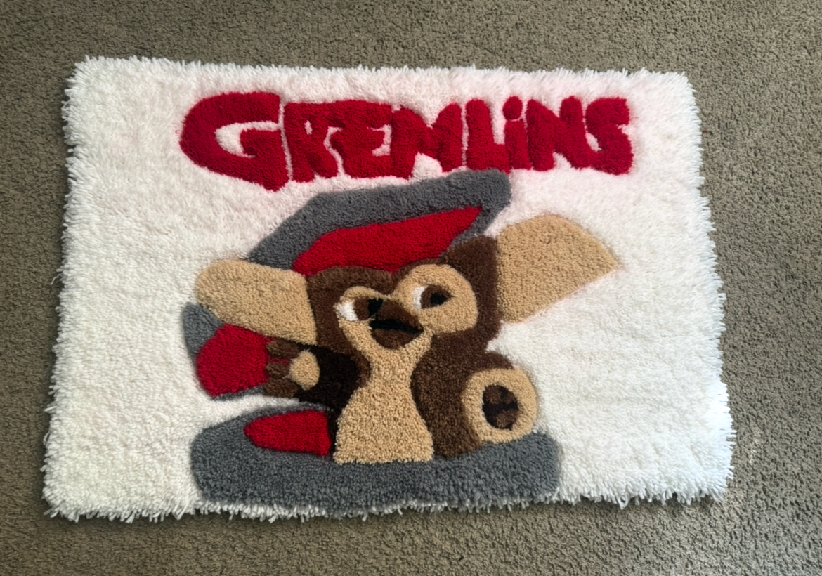 A colorful firefighting-themed rug showing a mole holding an axe and wearing a firefighter helmet with the word 'GLOWING' in red above.