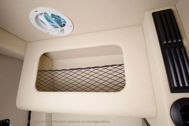 Interior view of an airplane cargo area with a mesh net, a vent, and a storage compartment.