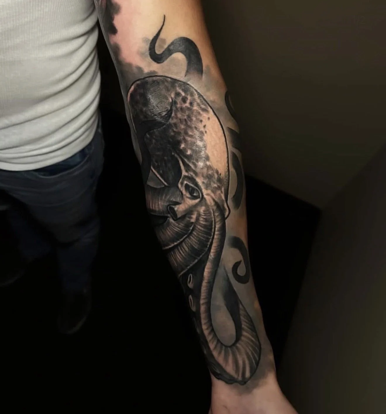 Detailed black and grey octopus tattoo wrapping the forearm, done by Cody Eckenrode at CREate Tattoo Studio.
