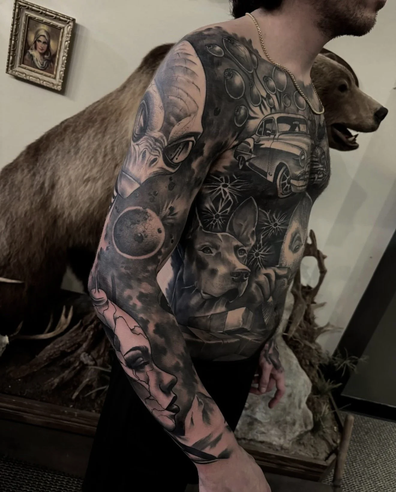 Full-arm outer space tattoo on a client with extensive upper-body tattoos, created by Cody Eckenrode at CREate Tattoo Studio.