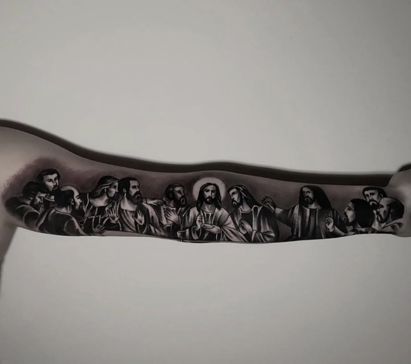 Detailed black and grey tattoo of The Last Supper scene, done by Cody Eckenrode at CREate Tattoo Studio.