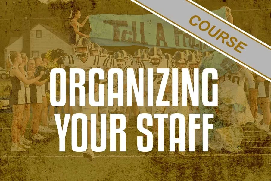 A group of cheerleaders in uniforms holding pom-poms and a group of football players in helmets and jerseys lined up together with cheerleaders on one side. A banner in the background reads 'Tackle a Fight.' The image promotes a course on organizing staff.