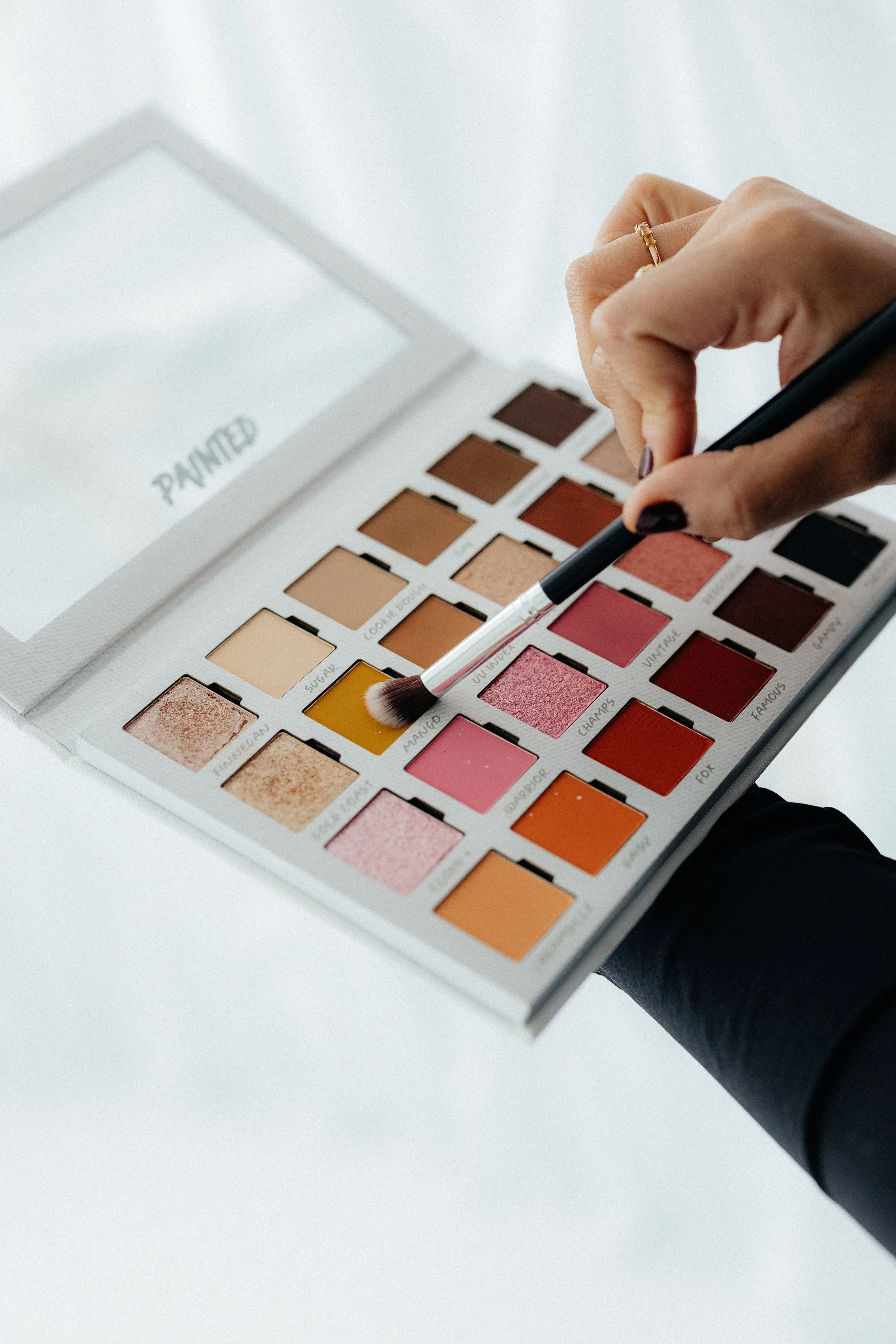 Makeup artist applying eyeshadow during a bridal makeup application.