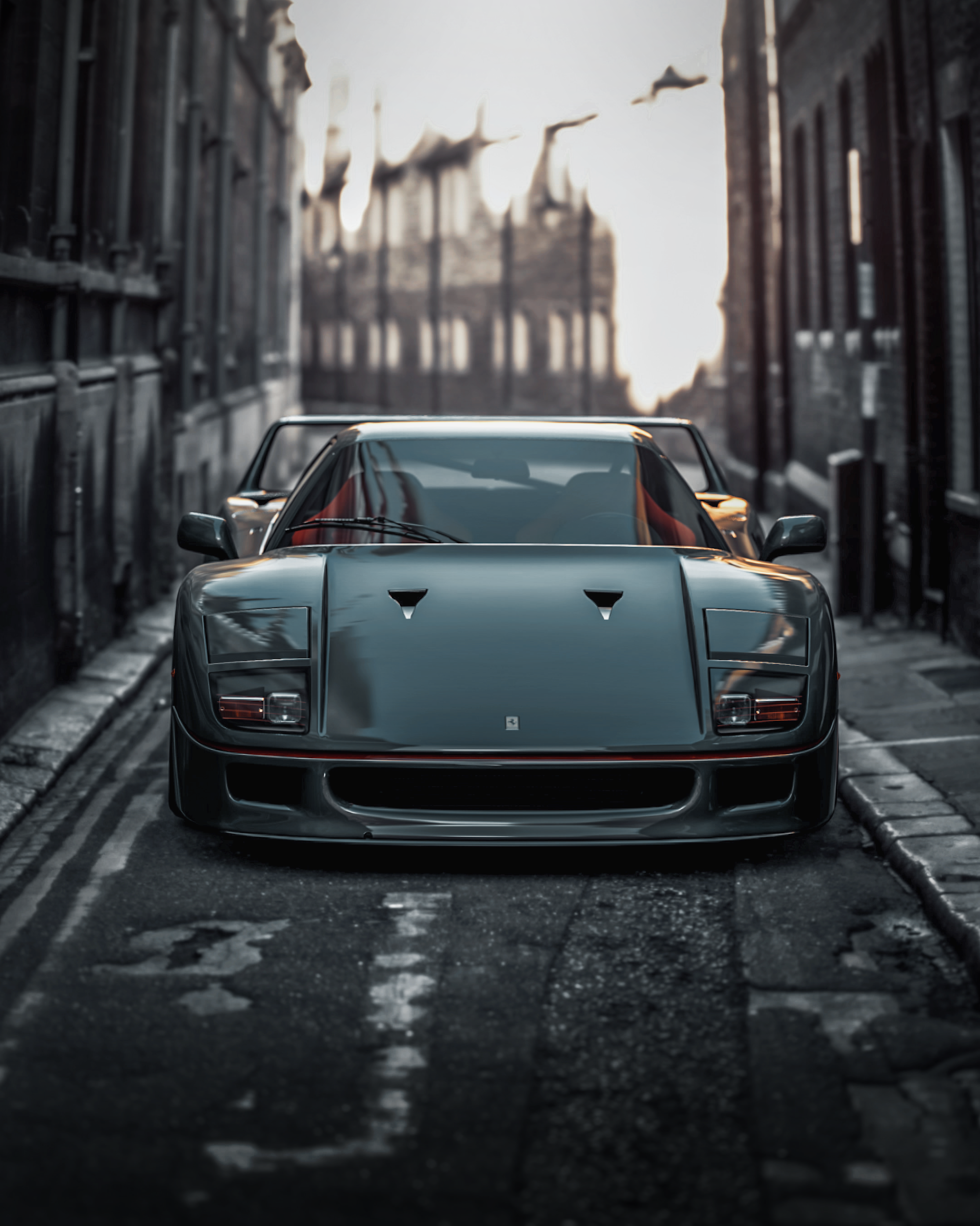 A black sports car parked on a narrow, urban street, with brick buildings on either side and blurred cityscape in the background at sunset.