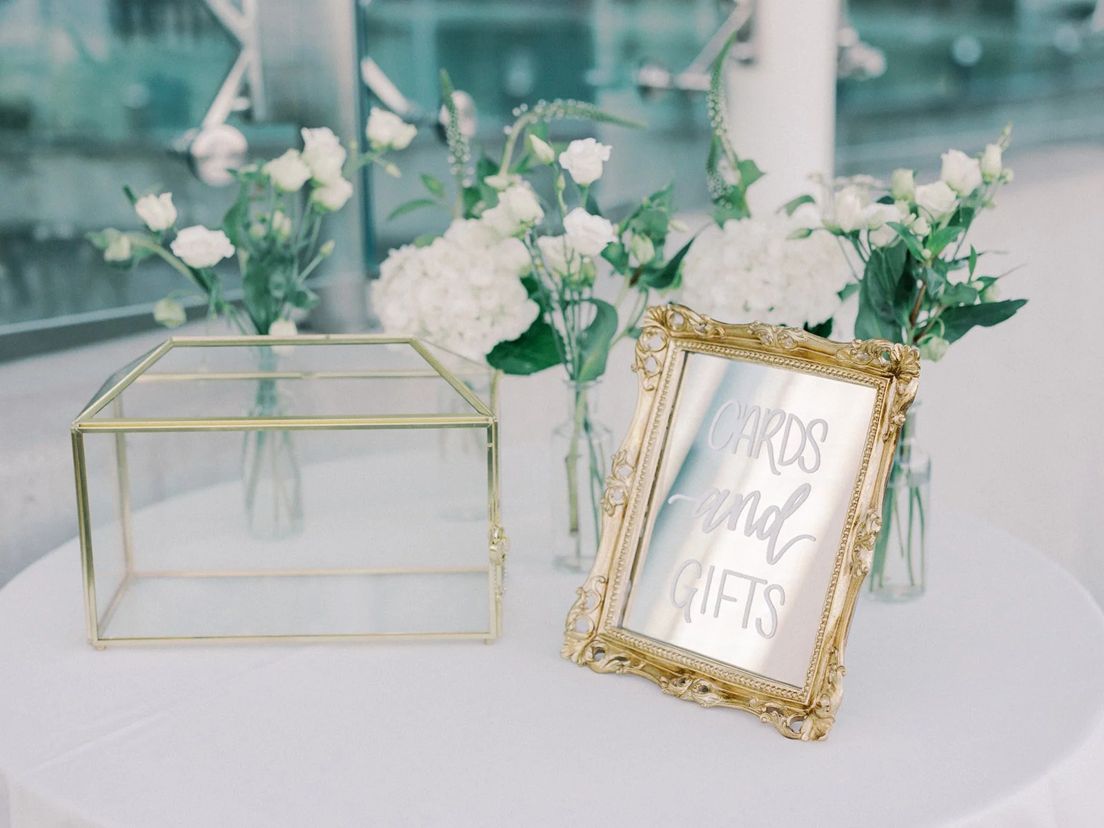 Vintage small gold floor mirror with hand-lettered calligraphy cards & gifts detail for a classic Boston wedding at the New England Aquarium