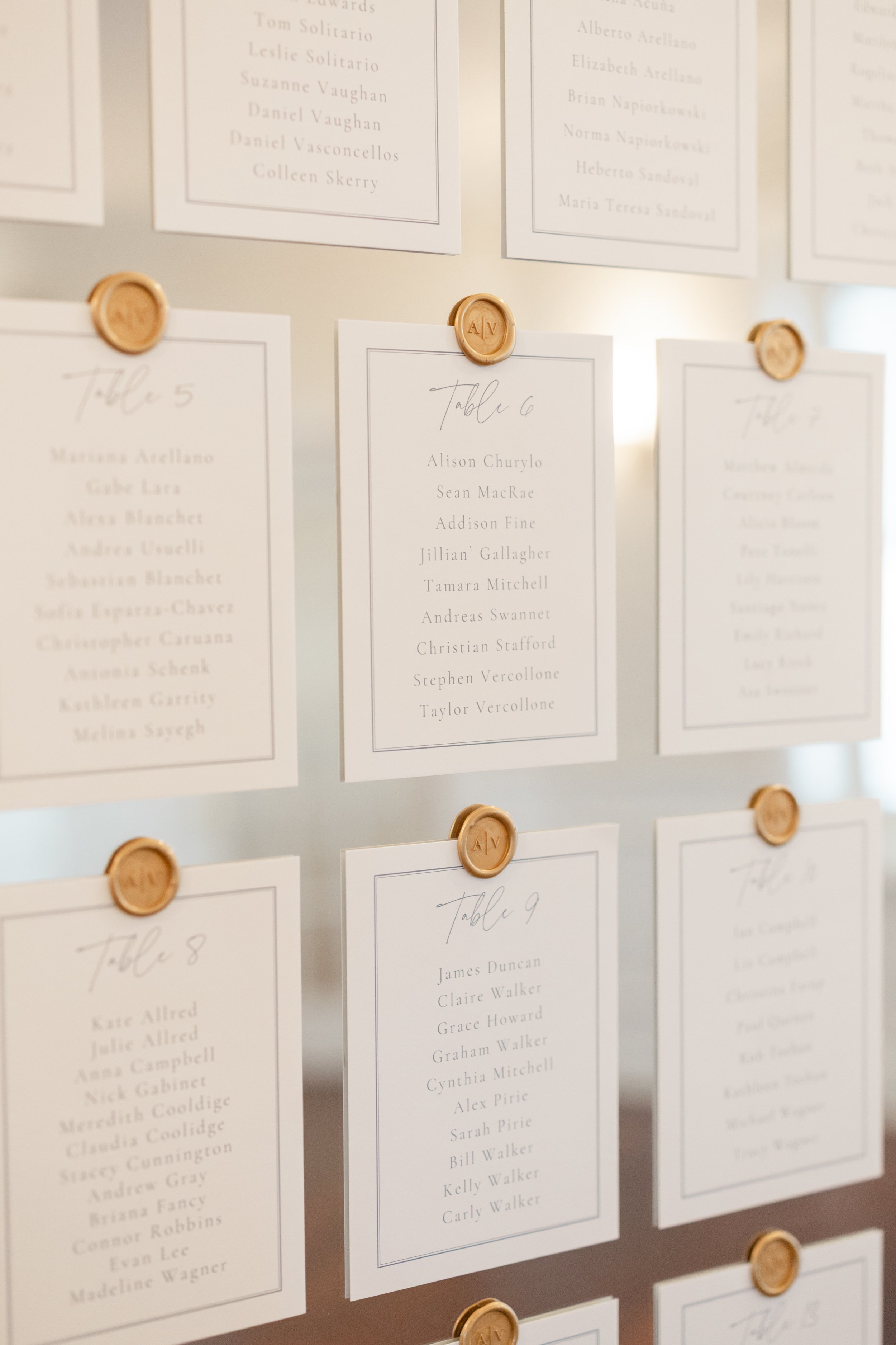 Custom, modern card stock and wax seal seating chart on a vintage gold, oversized mirror at the classic OceanCliff Hotel in Newport, RI