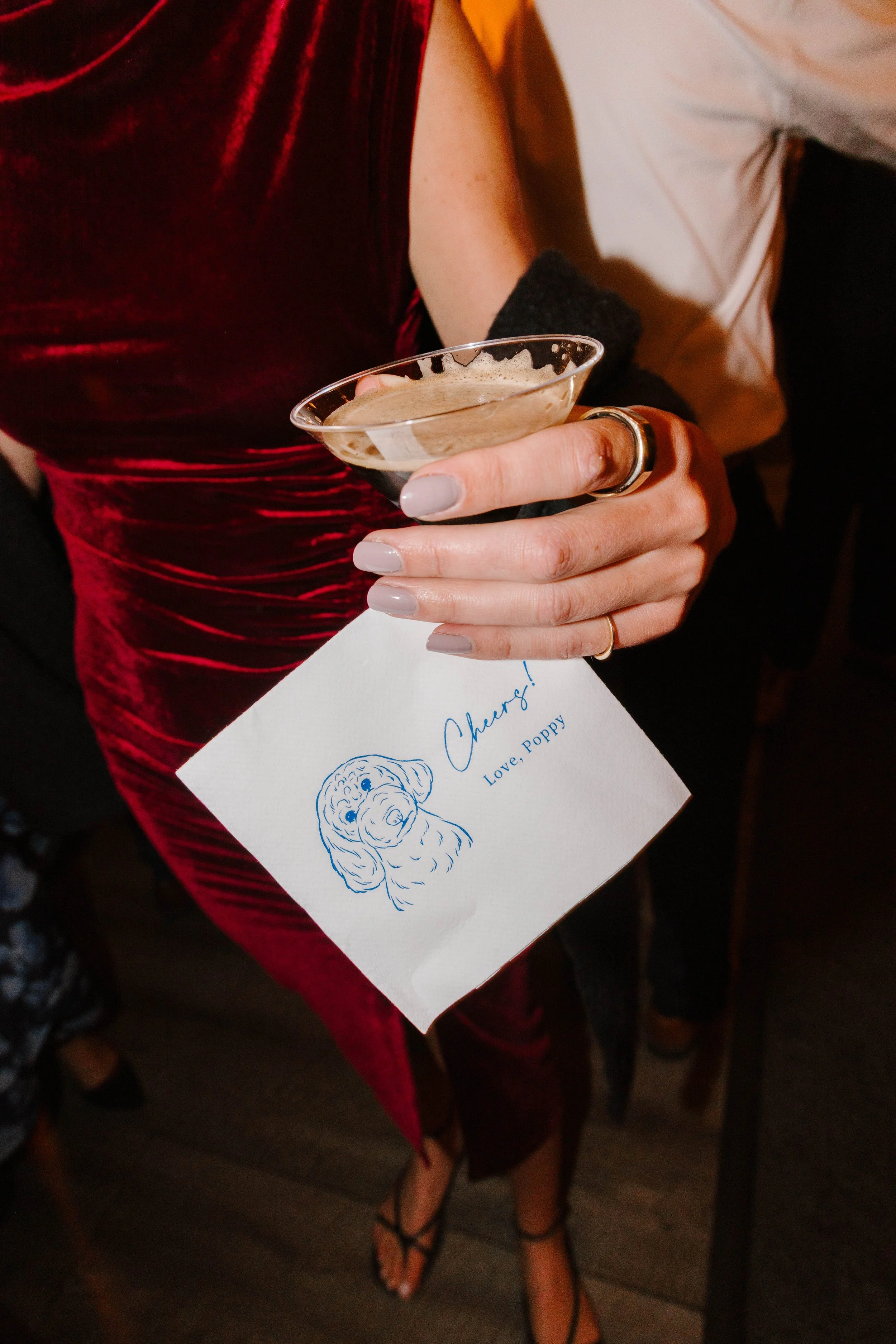 White and navy blue personalized wedding cocktail napkins with pet drawing for a coastal wedding at the Inn at Diamond Cove