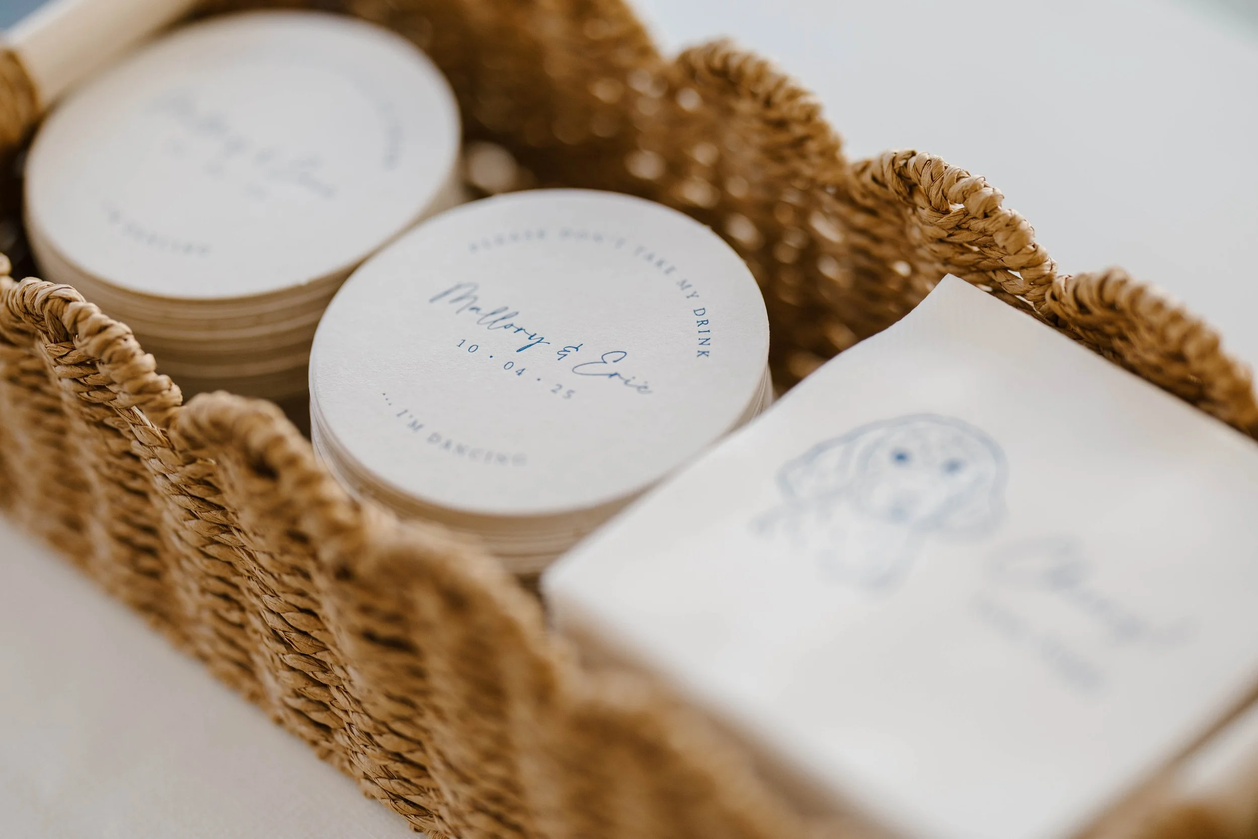 White and navy blue personalized wedding coasters and cocktail napkins with pet drawing for a coastal wedding at the Inn at Diamond Cove