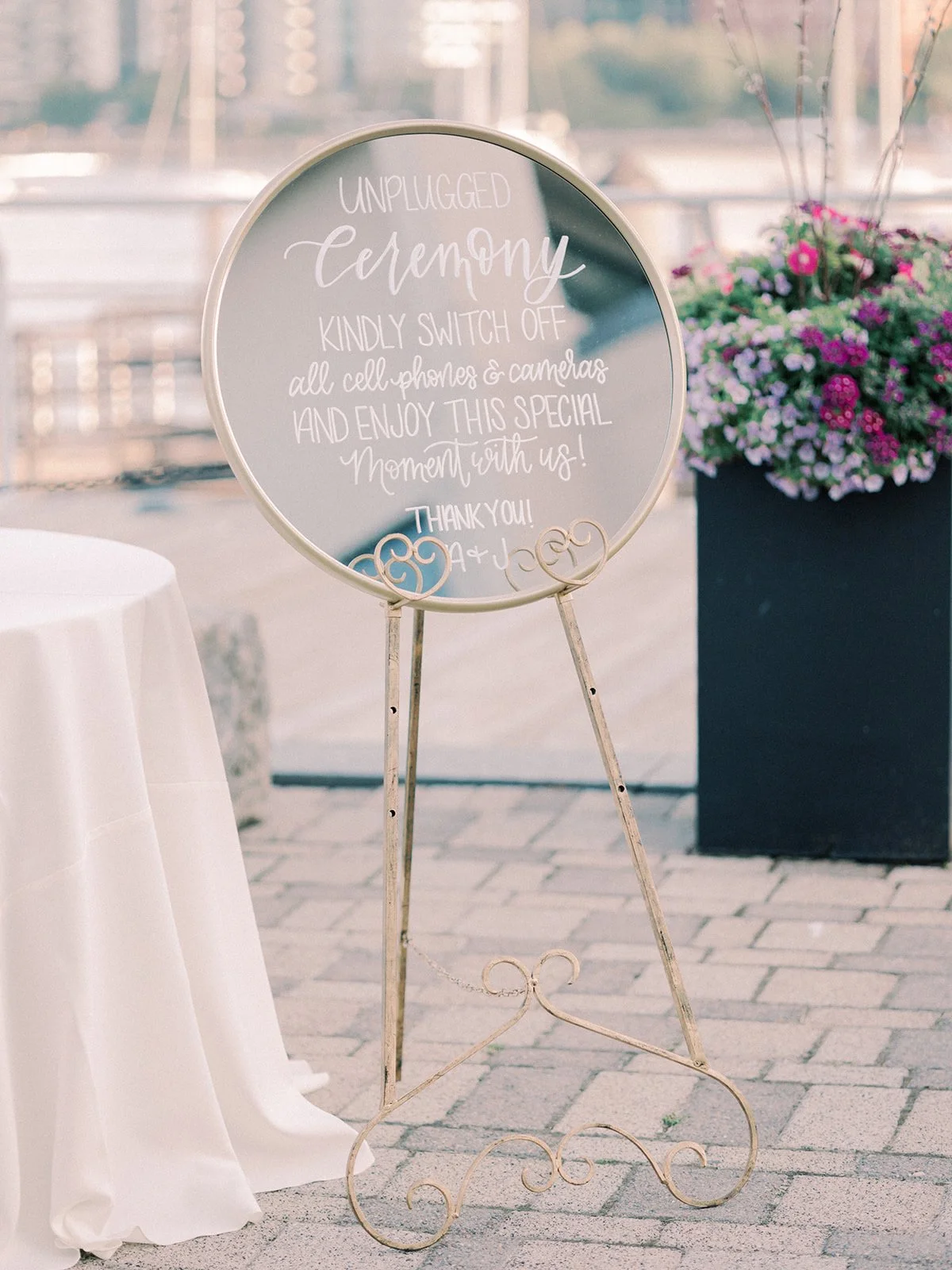 Ornate gold mirror wedding unplugged ceremony sign featuring white hand-lettered calligraphy at a Boston wedding reception - New England Aquarium