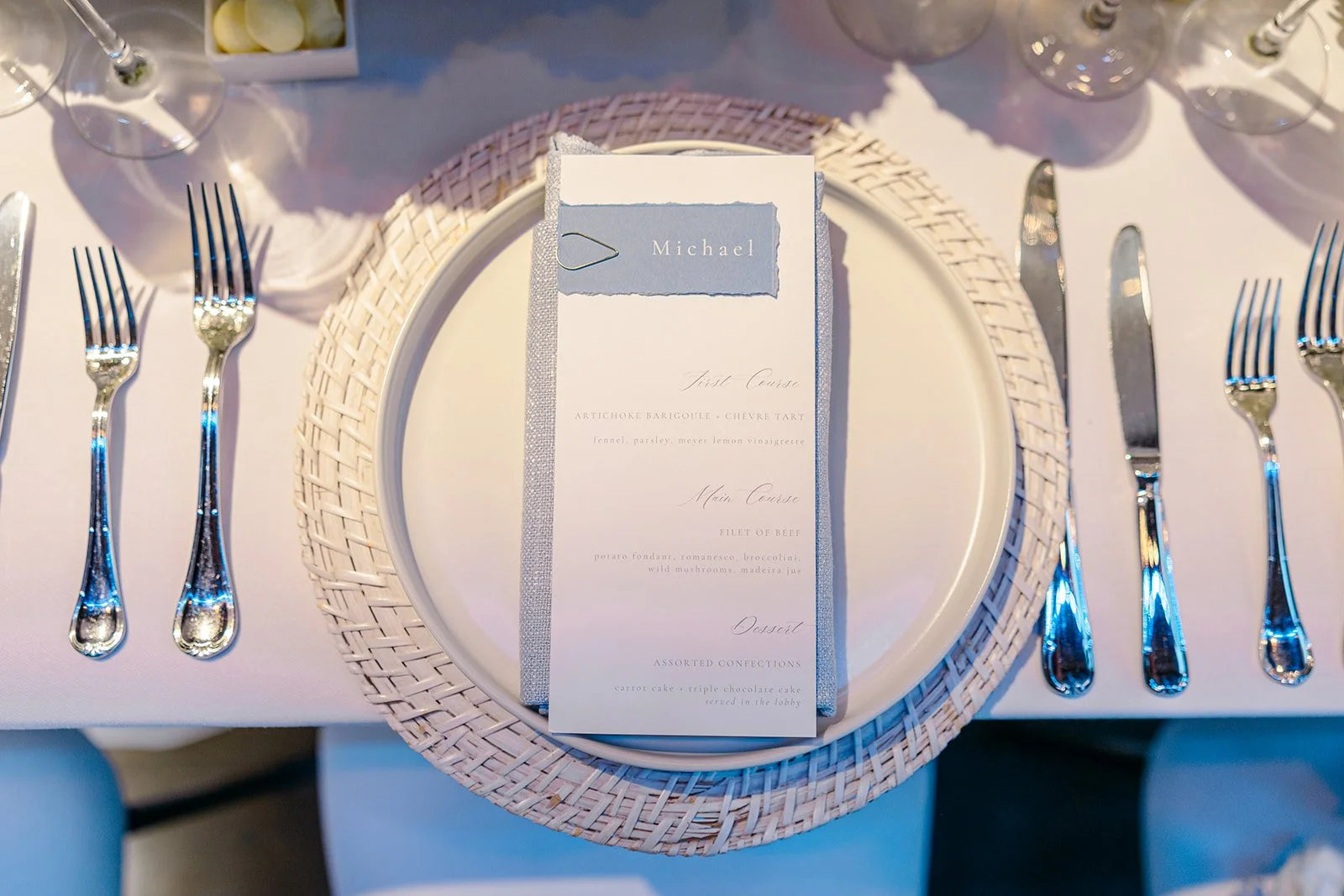 Custom, personalized dinner menu with coastal blue deckled-edge name tag with white in and gold clip and hydrangea background for a classic, elegant coastal wedding at the ICA in Boston, MA