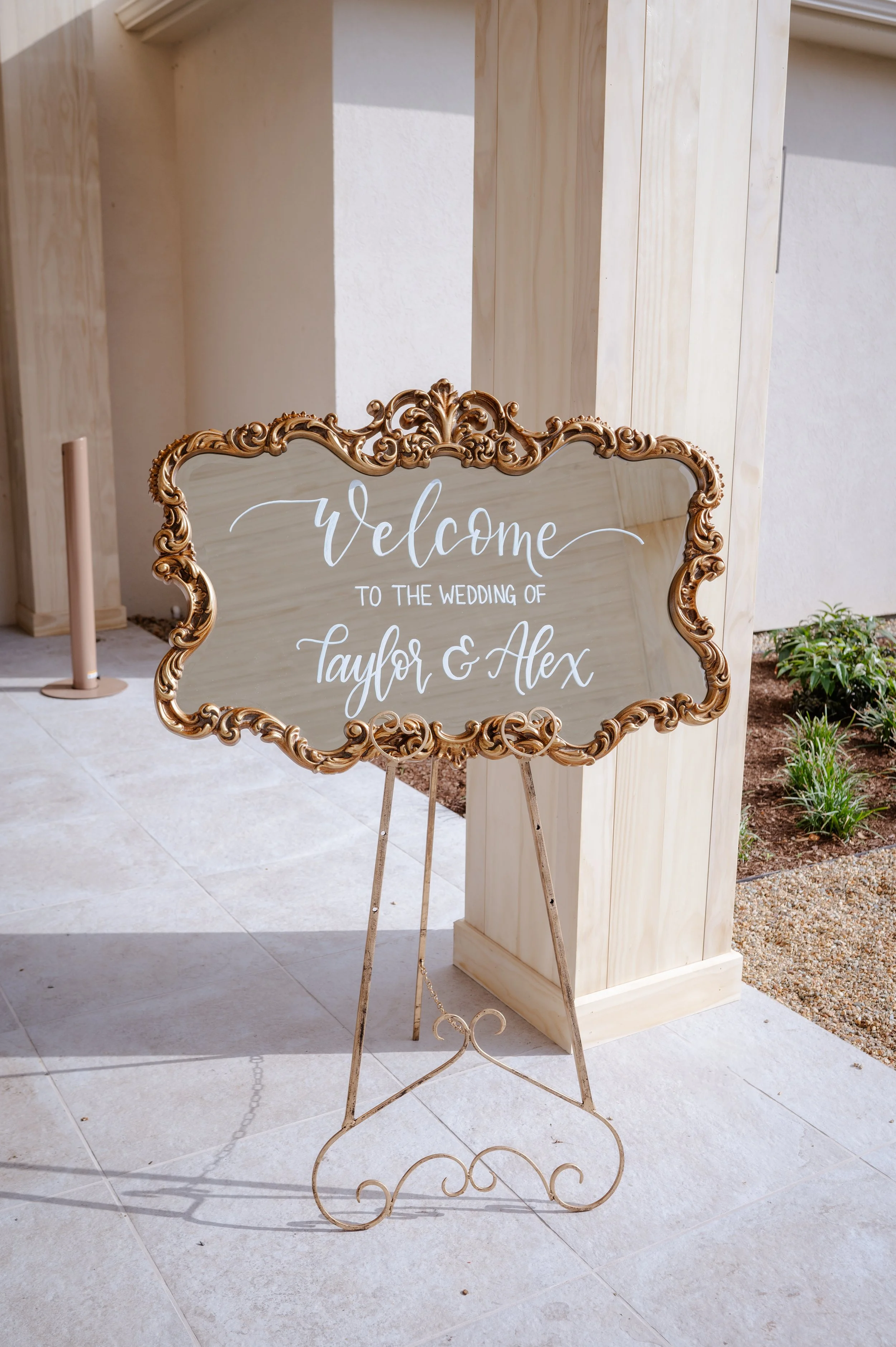 Vintage gold floor mirror with hand-lettered calligraphy welcome for a classic wedding at The Lakehouse.