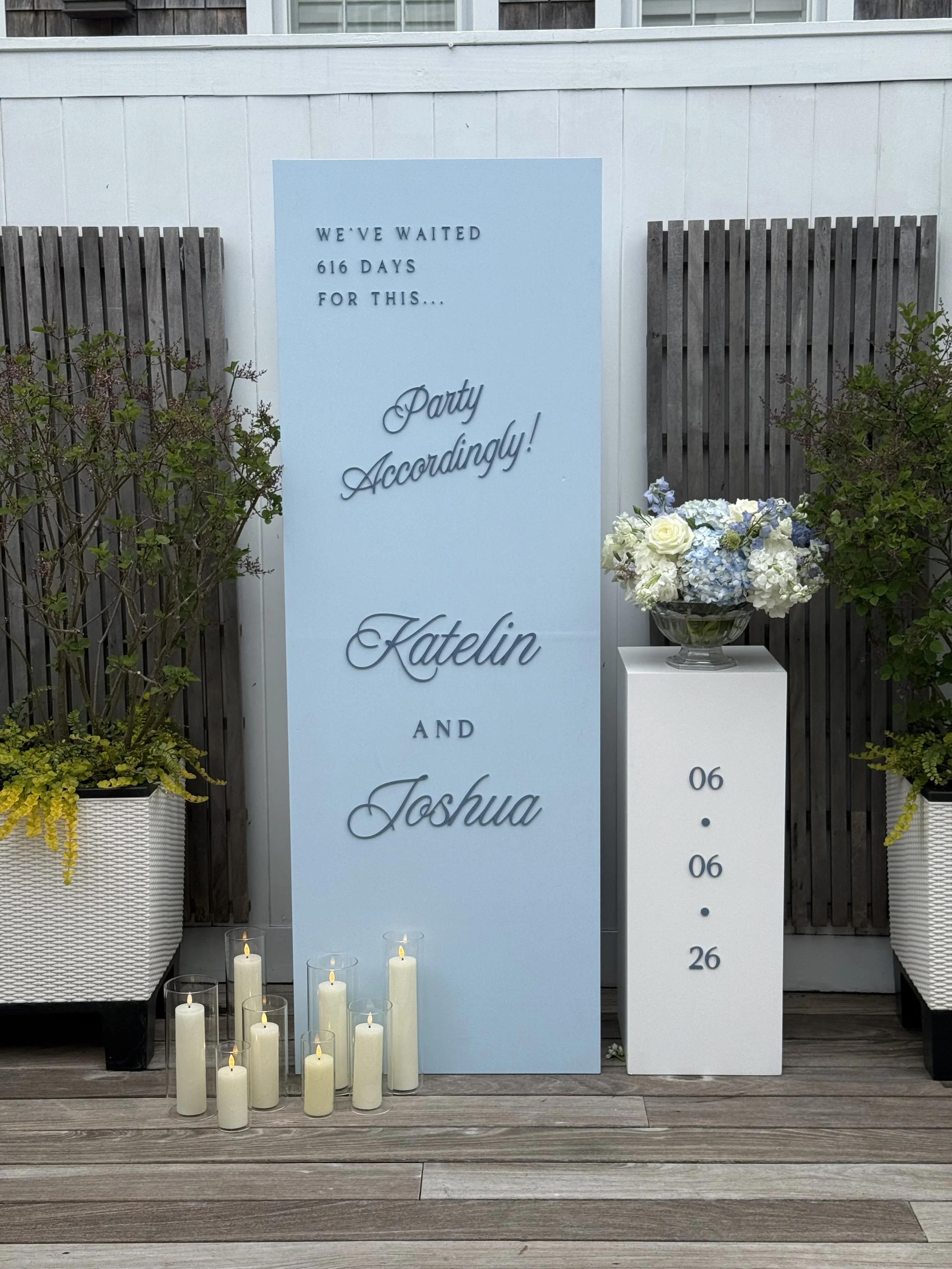 Bespoke statement wedding welcome sign with 3D acrylic letters, LED candles and a white pedestal with florals and their wedding date, for a wedding at the Nantucket Hotel & Resort in Nantucket, MA