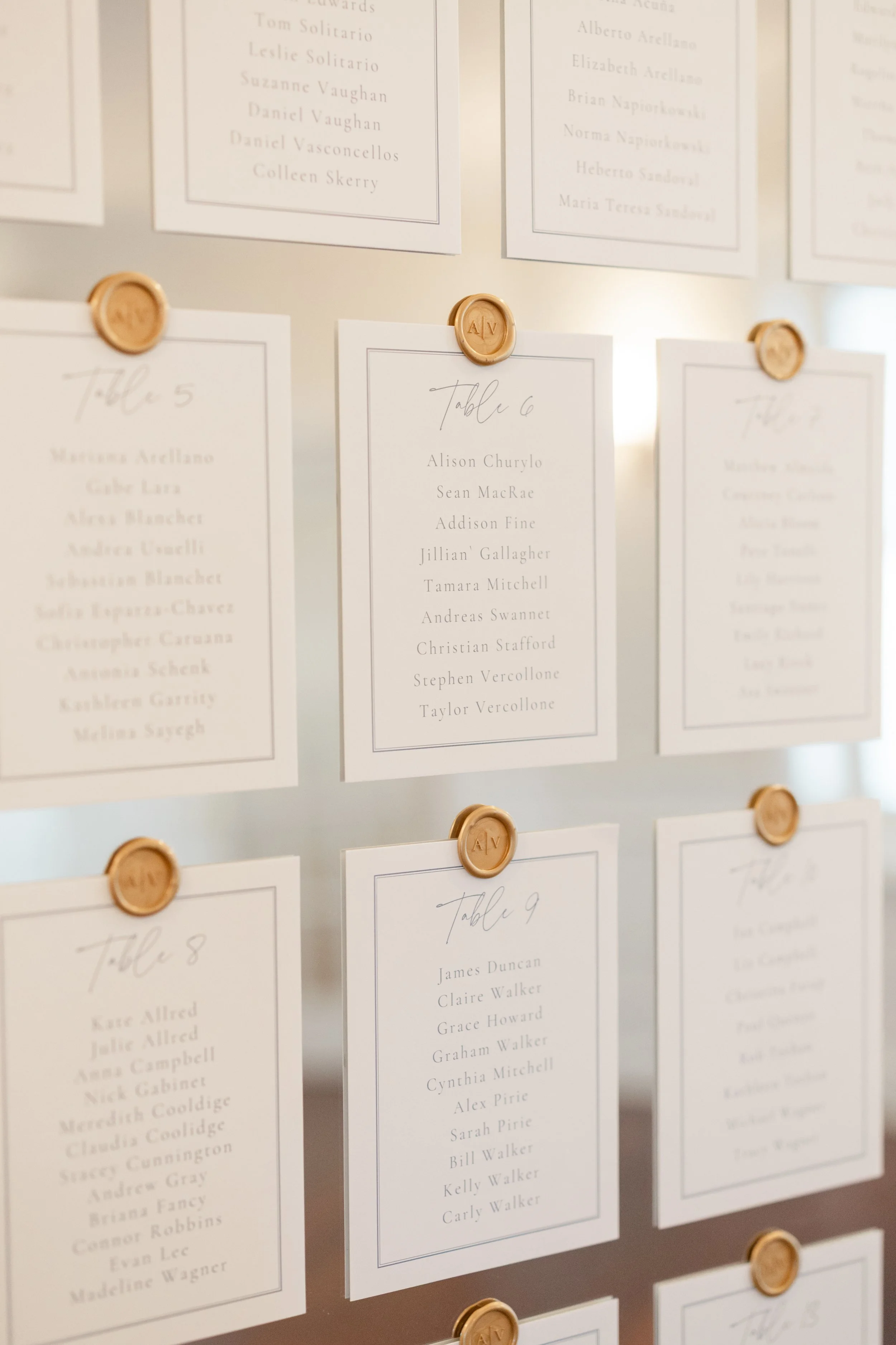 Ornate gold mirror wedding seating chart featuring luxury card stock and custom wax seals at a Newport wedding reception - OceanCliff Hotel
