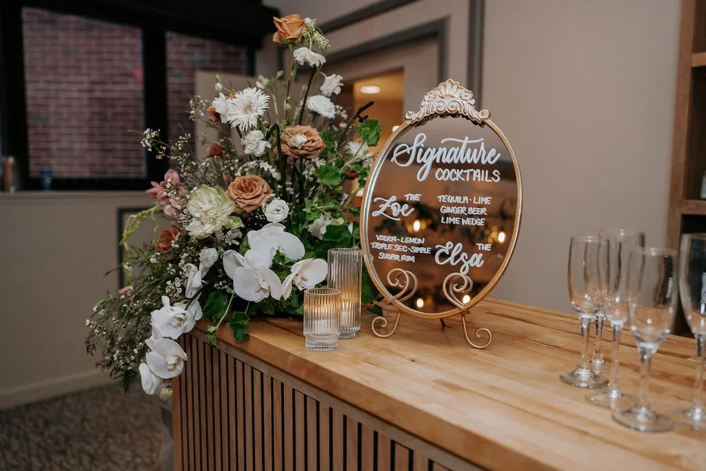 Vintage ornate gold mirror wedding signature cocktail sign featuring white hand-lettered calligraphy - Bostonian Hotel